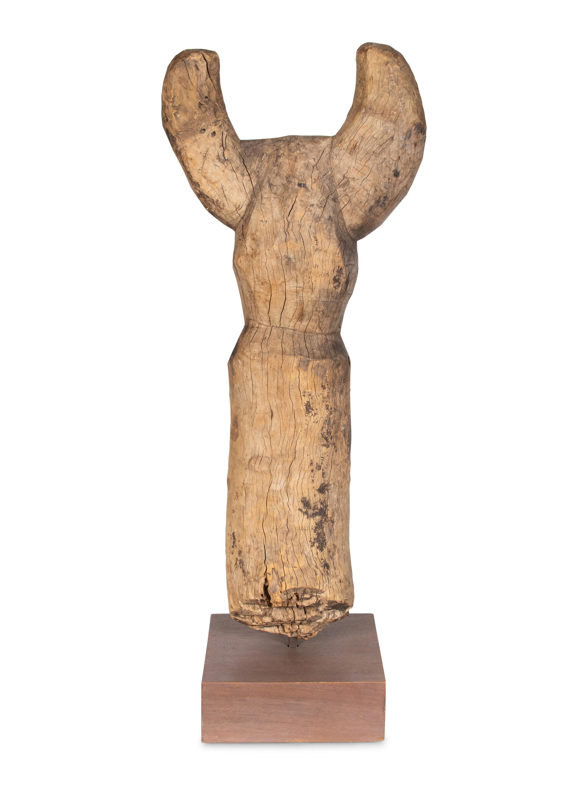 A Yaka Post, with forked finial painted blue and white, a mask in relief at the center