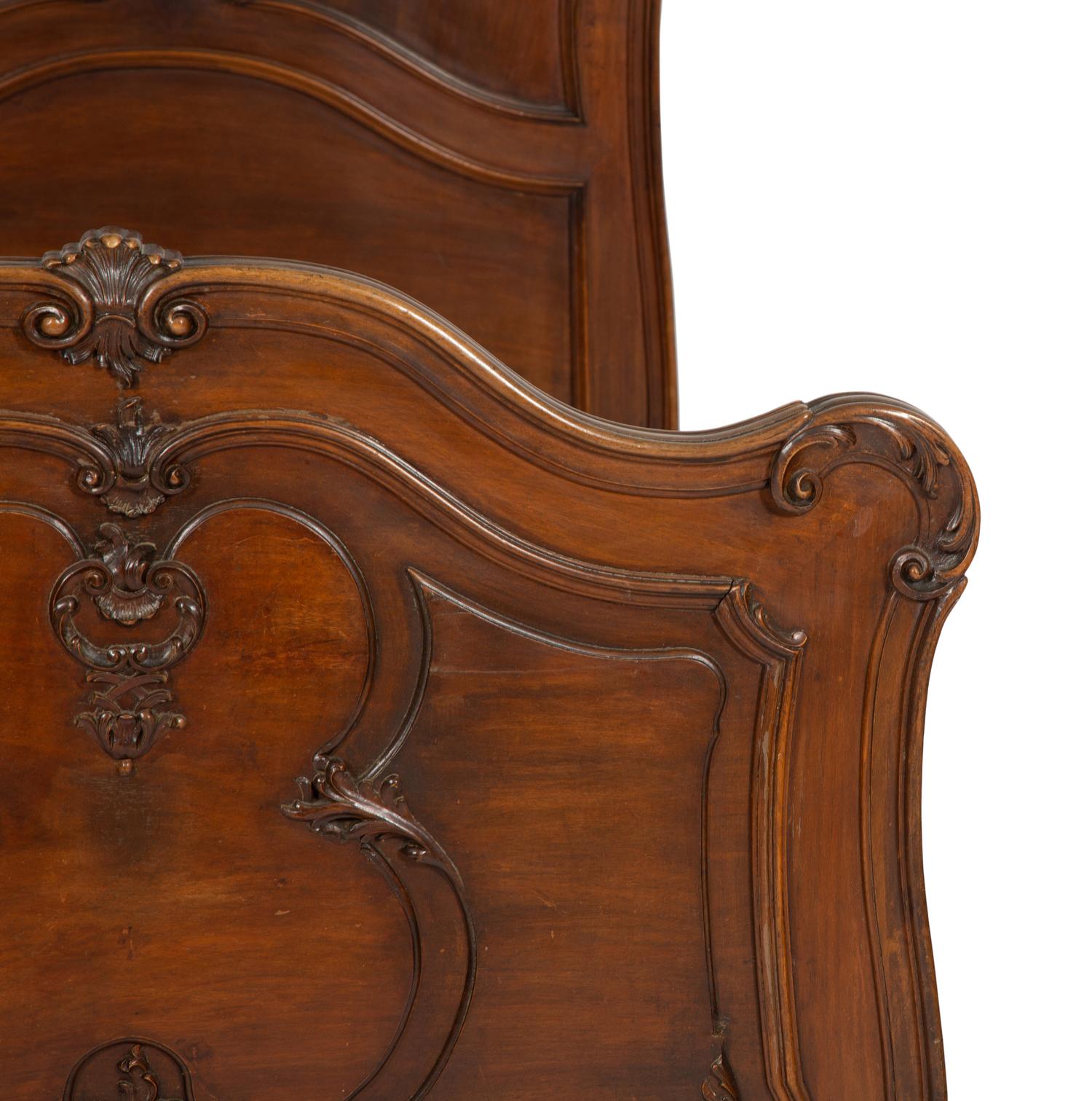 A Pair of American Victorian Carved Mahogany Twin Beds