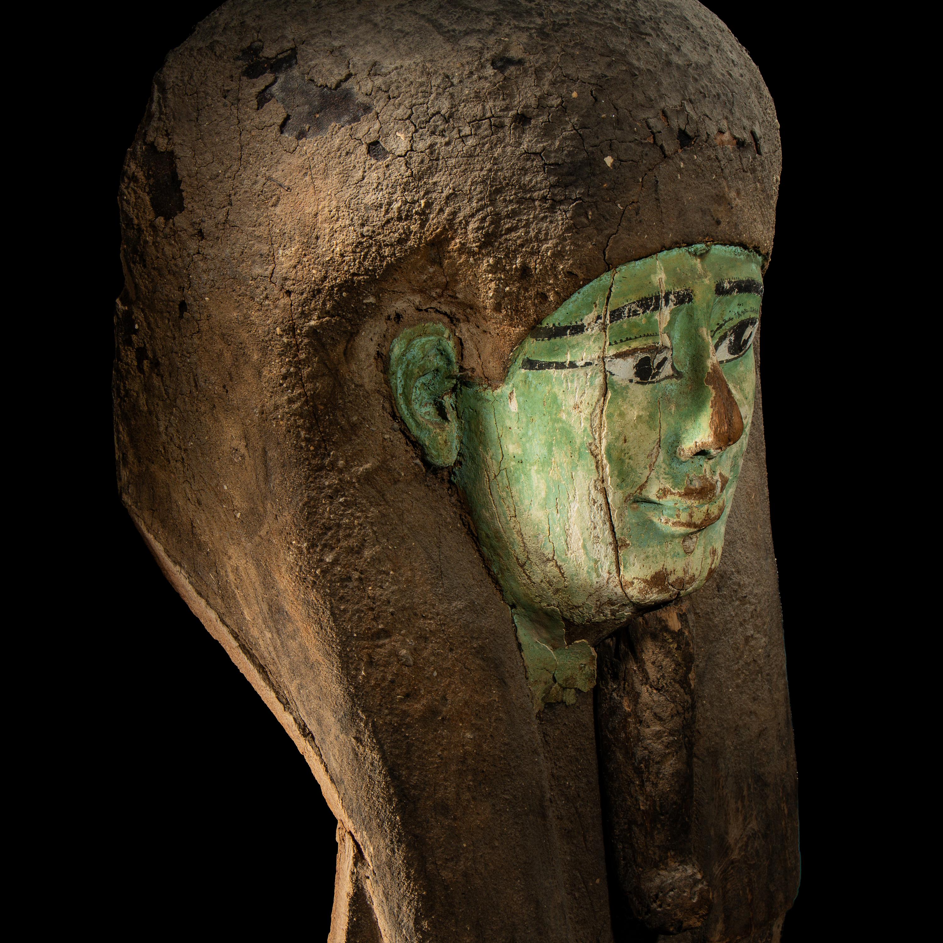 An Egyptian Painted Wood Sarcophagus Head