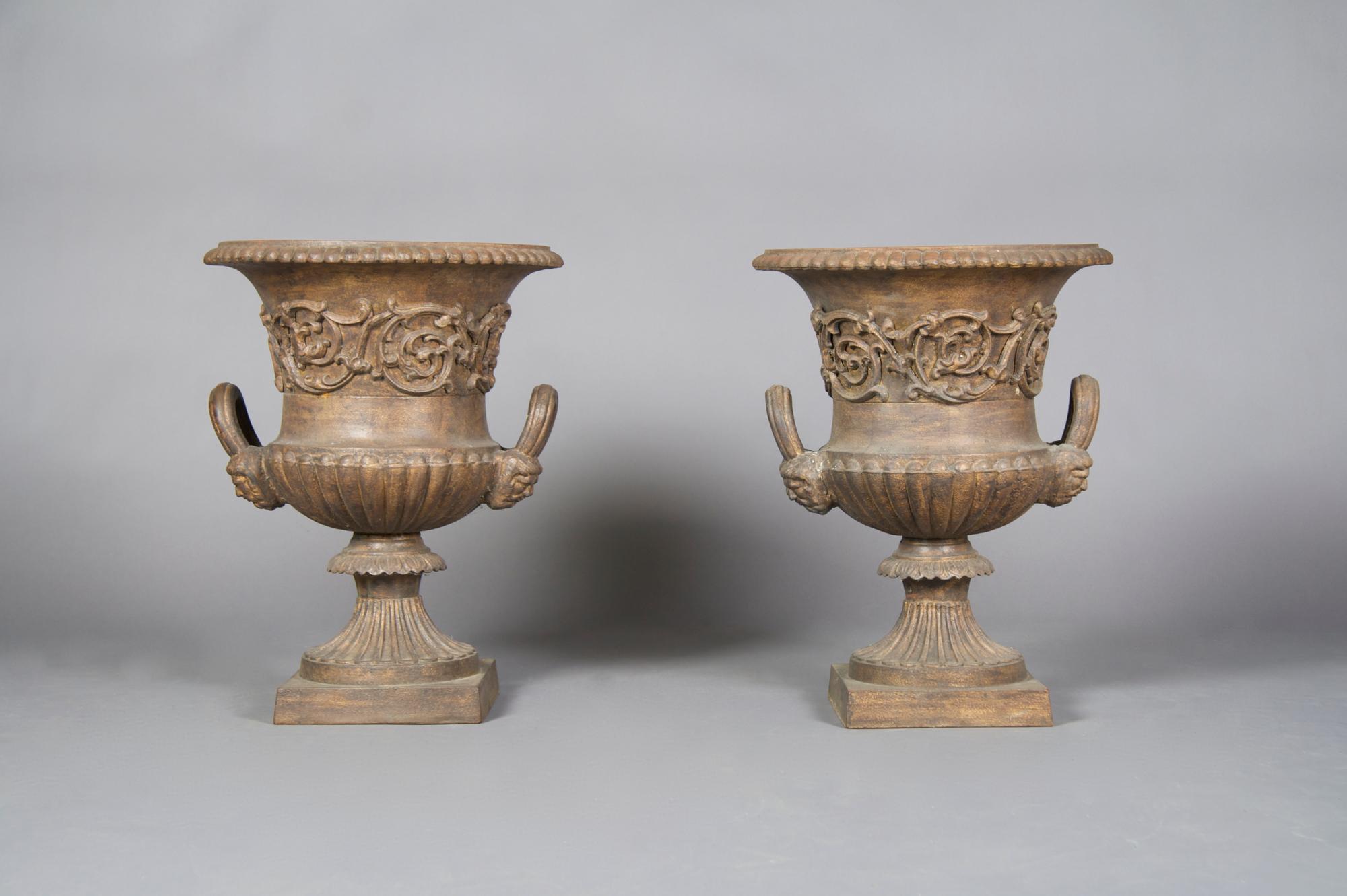 A Pair of Victorian Style Cast Iron Urns, Height 22 1/2 inches.