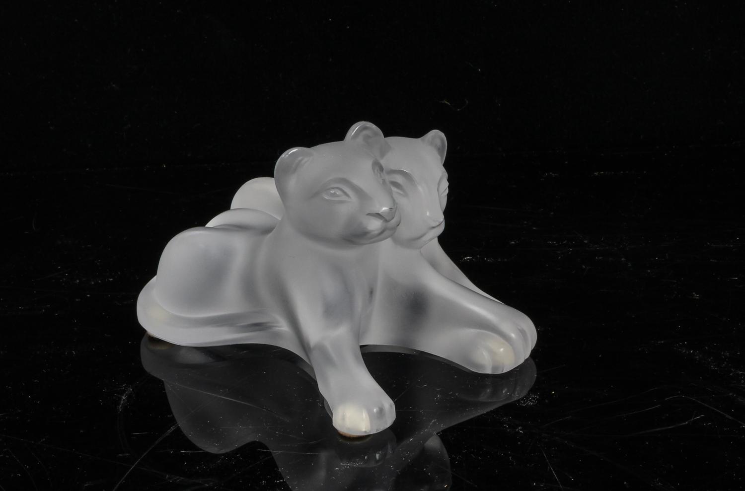 A Lalique Molded and Frosted Glass Figural Group Height 3 inches.