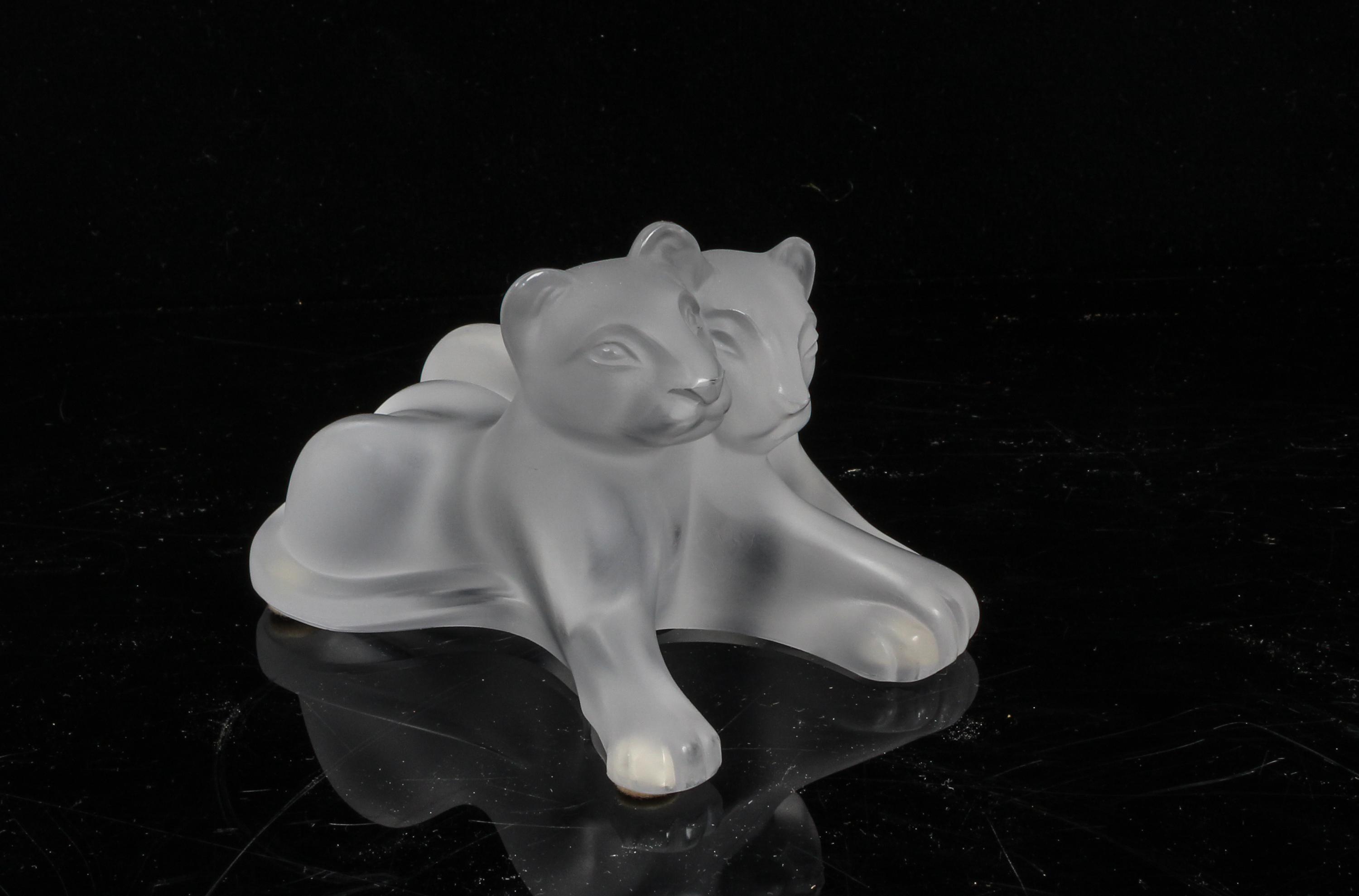 A Lalique Molded and Frosted Glass Figural Group Height 3 inches.