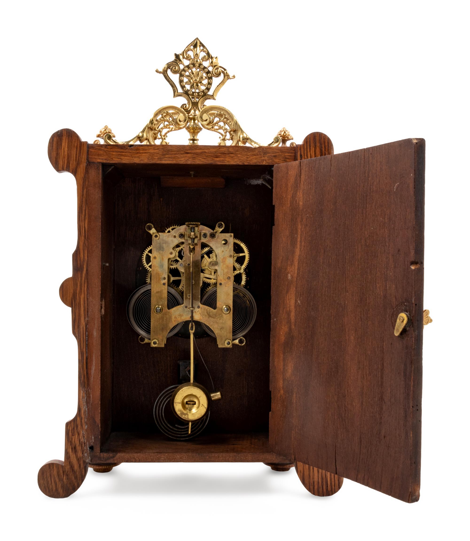 An Ansonia Cabinet B Gilt Metal Mounted Oak Shelf Clock