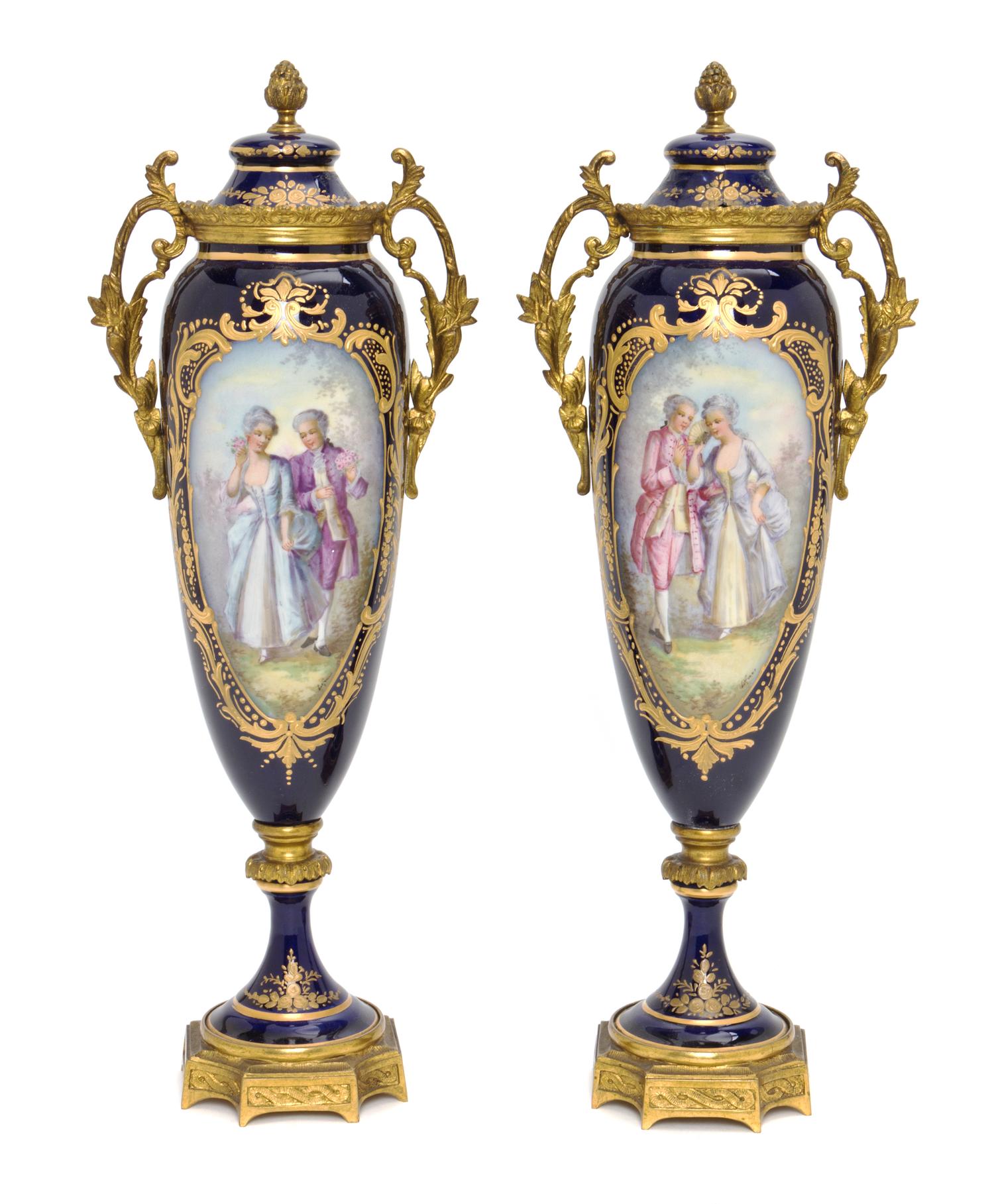 A Pair of Sevres Style Porcelain and Gilt Bronze Mounted Covered Urns, Height 13 1/2 inches.