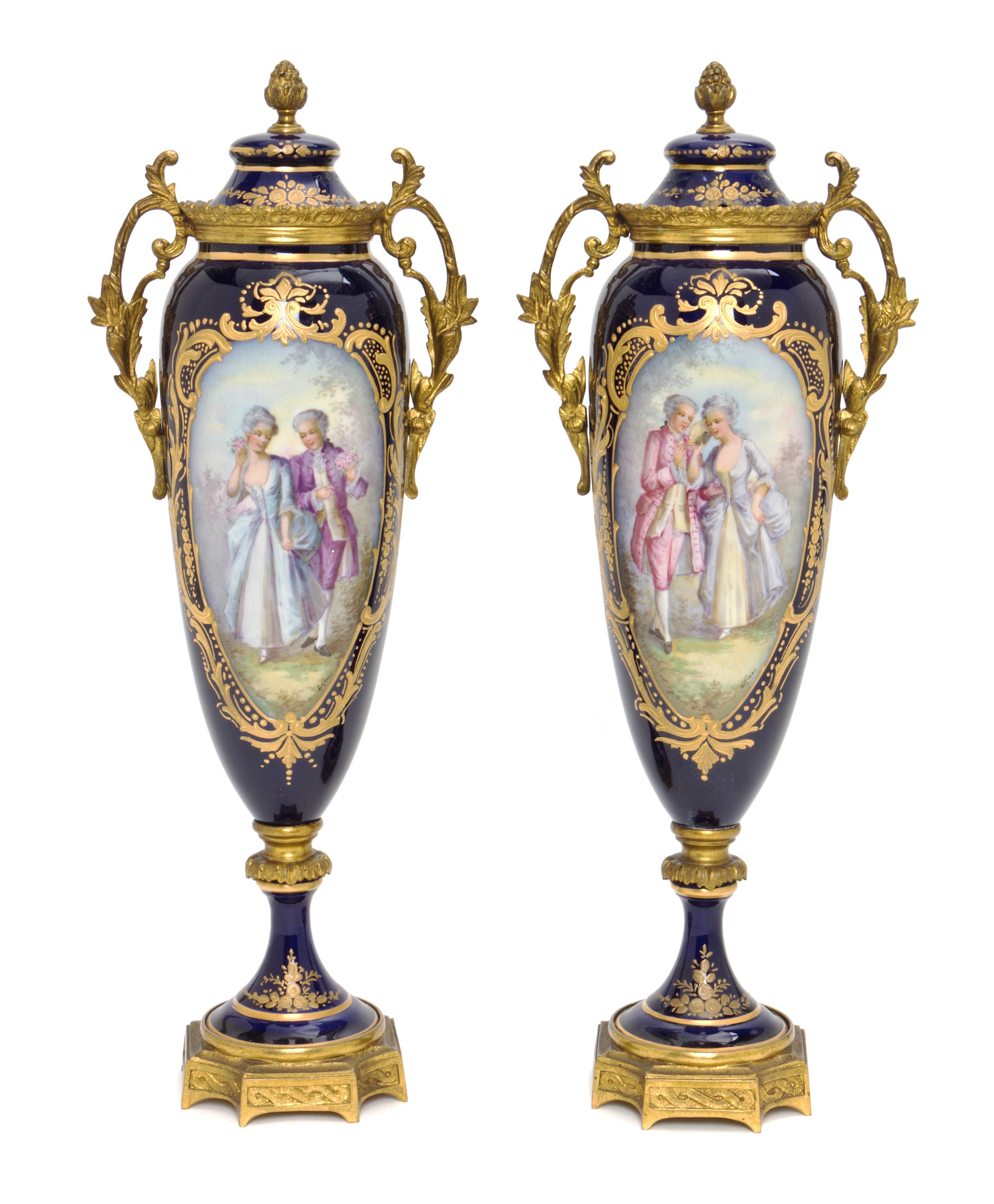 A Pair of Sevres Style Porcelain and Gilt Bronze Mounted Covered Urns, Height 13 1/2 inches.