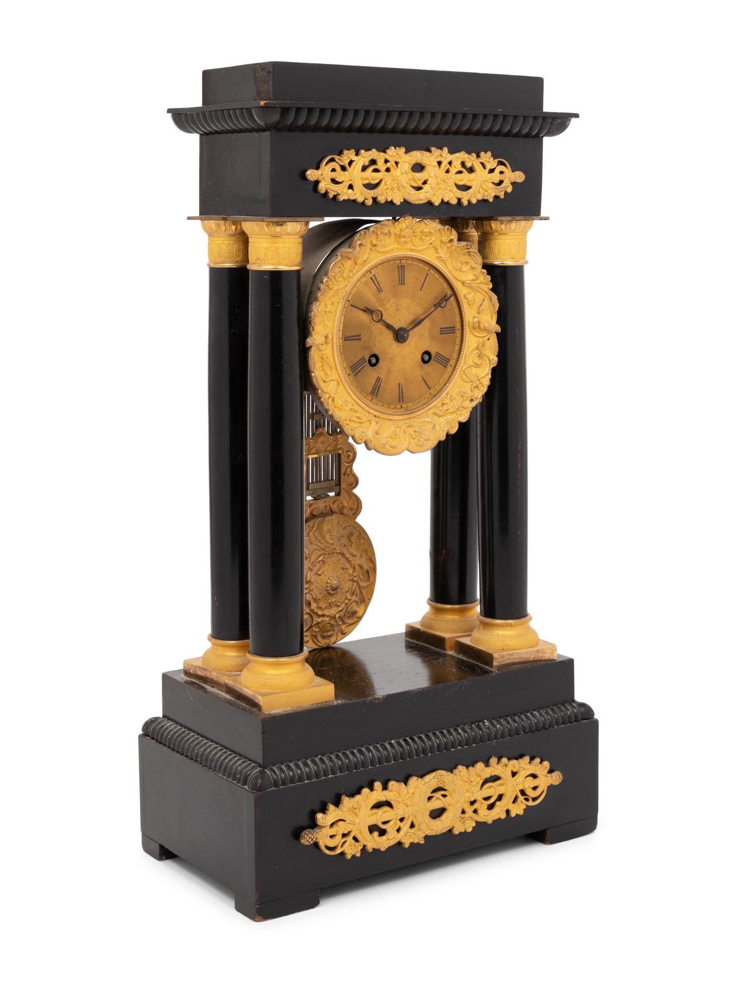 An Empire Style Gilt Bronze Mounted Ebonized Portico Clock