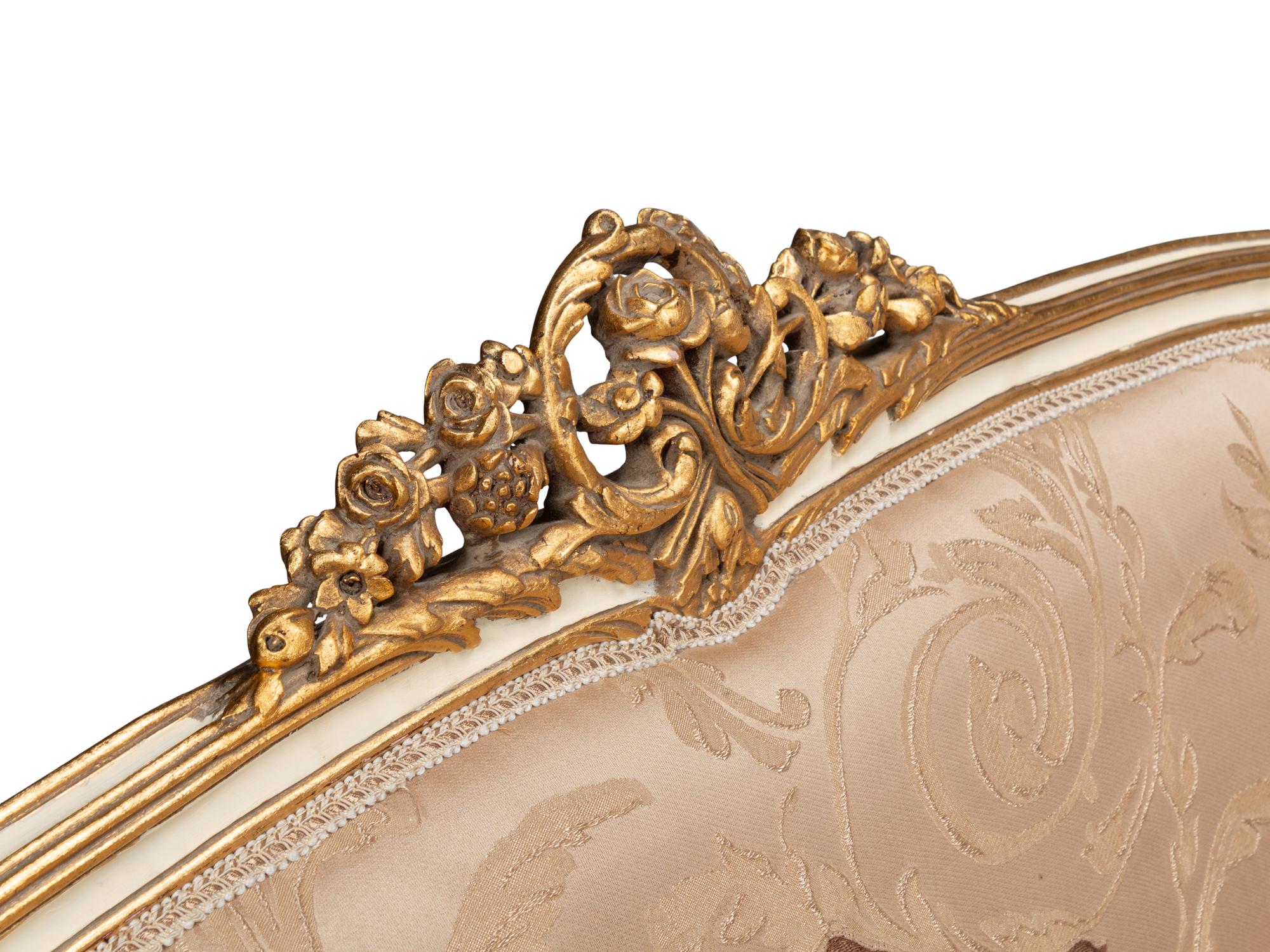 A Pair of Louis XV Style Cream-Painted and Parcel Gilt Settees