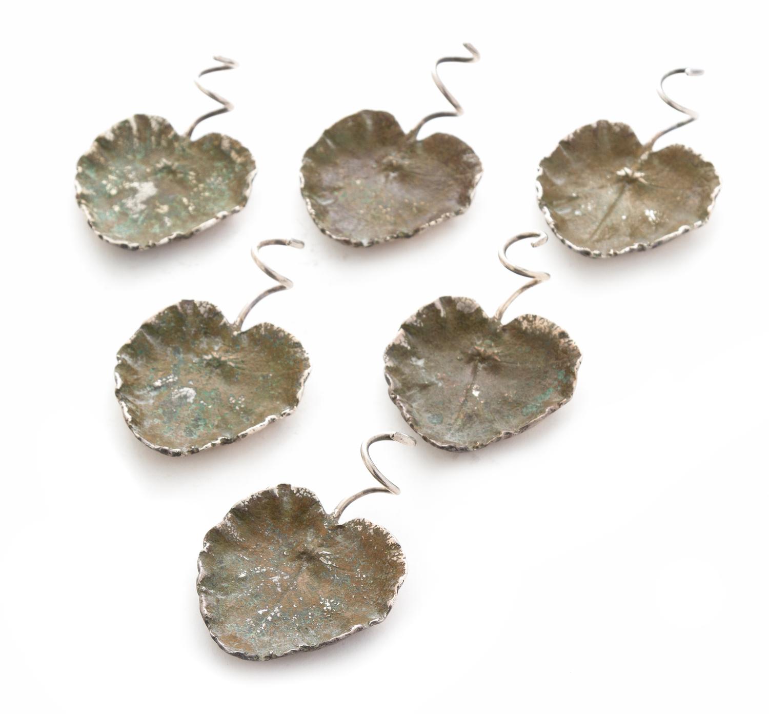 A Set of Six Verdigris Patinated Silver Salt Cellars, Emilio Maraffi for Cartier, New York, NY, each of leaf form with a spiral twist s