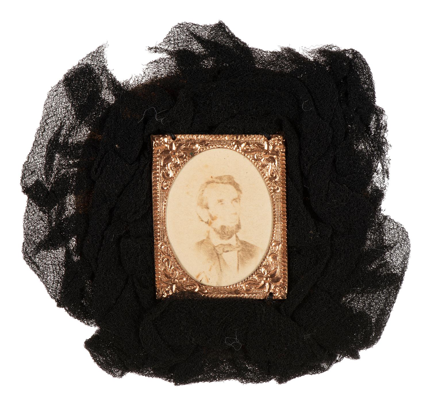 [LINCOLN, Abraham (1809-1865)]. Lincoln mourning cockade with albumen photograph at center.