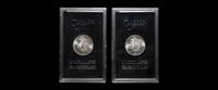 A Group of Two 1880-CC GSA: Morgan $1 Coins