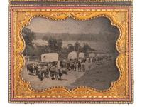 [EARLY PHOTOGRAPHY]. Ambrotype of seven ox-drawn wagons on a road, possibly in Nebraska City, NE. Ca 1859.