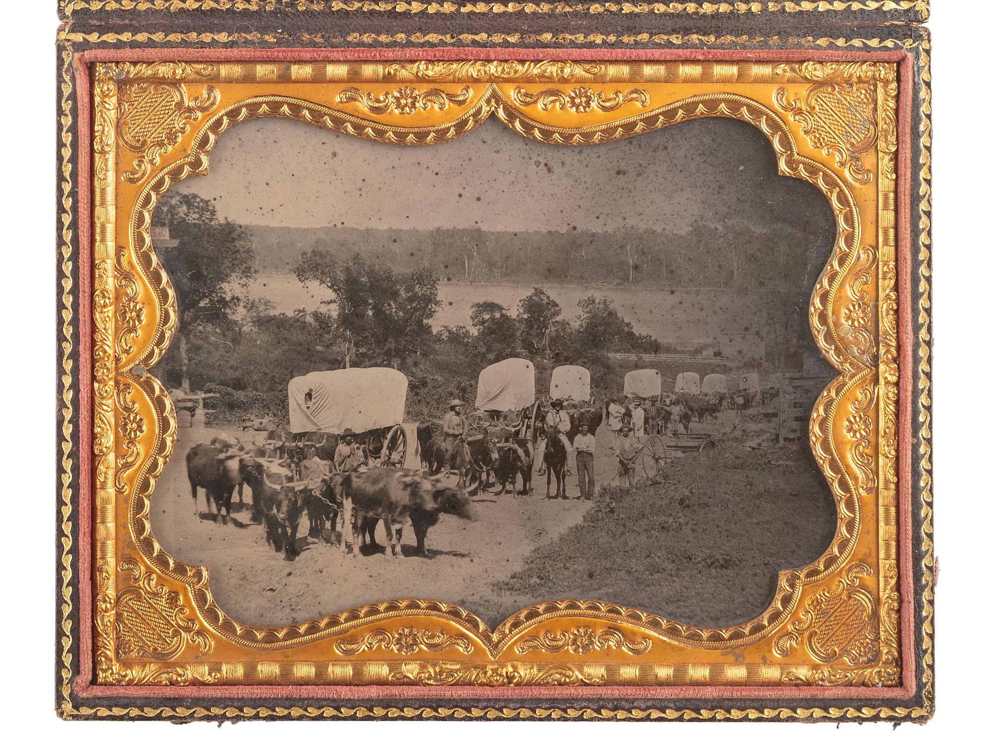 [EARLY PHOTOGRAPHY]. Ambrotype of seven ox-drawn wagons on a road, possibly in Nebraska City, NE. Ca 1859.