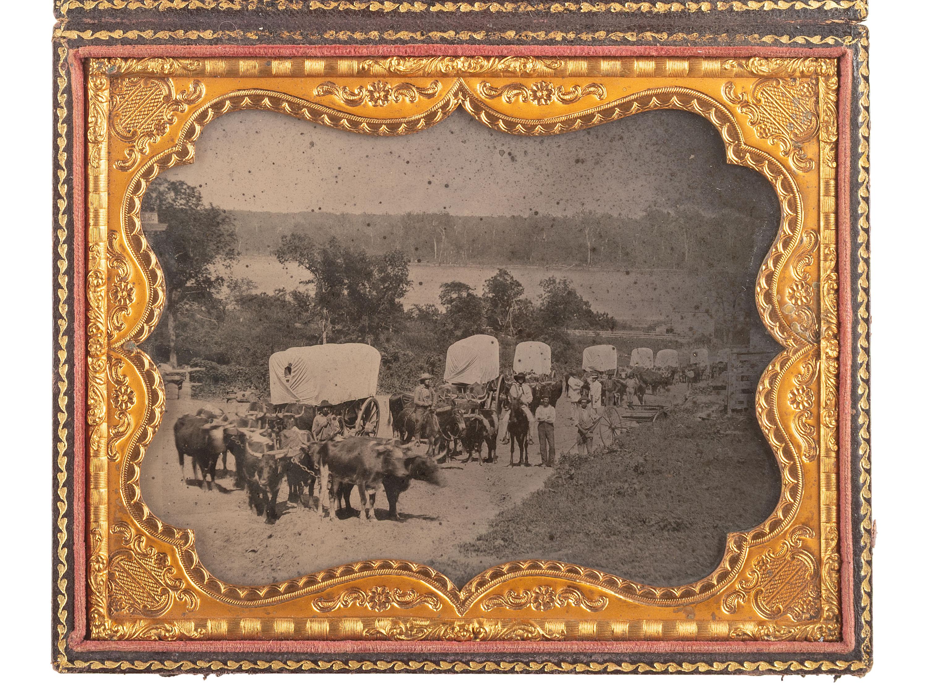 [EARLY PHOTOGRAPHY]. Ambrotype of seven ox-drawn wagons on a road, possibly in Nebraska City, NE. Ca 1859.