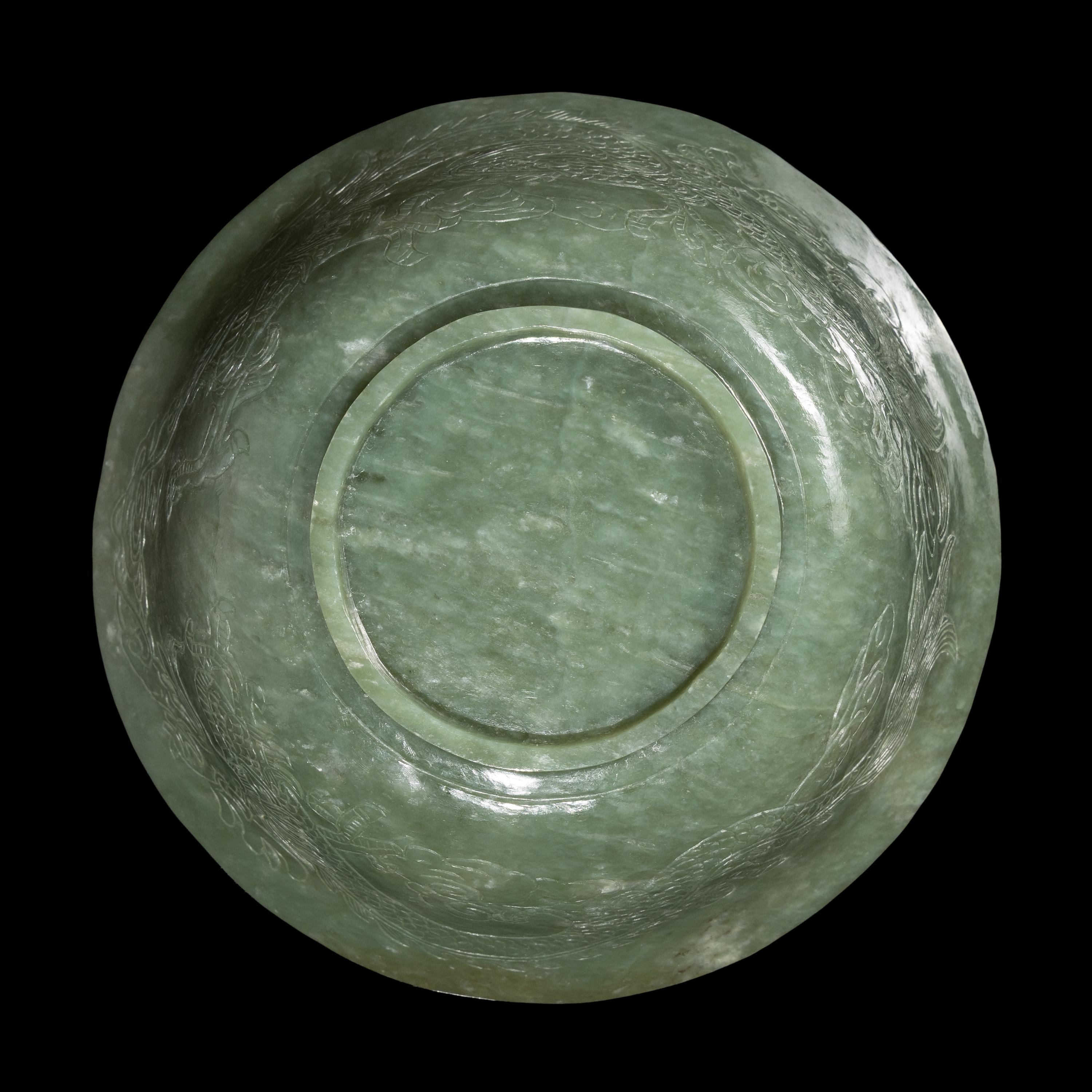 A Chinese Celadon Jade 'Dragon' Bowl, 20th Century 近代 青玉刻龍紋碗