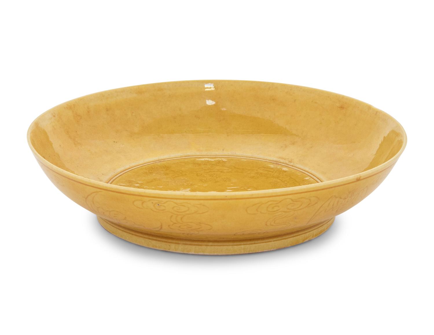 An Incised Yellow Glazed Porcelain 'Cranes and Pines' Plate