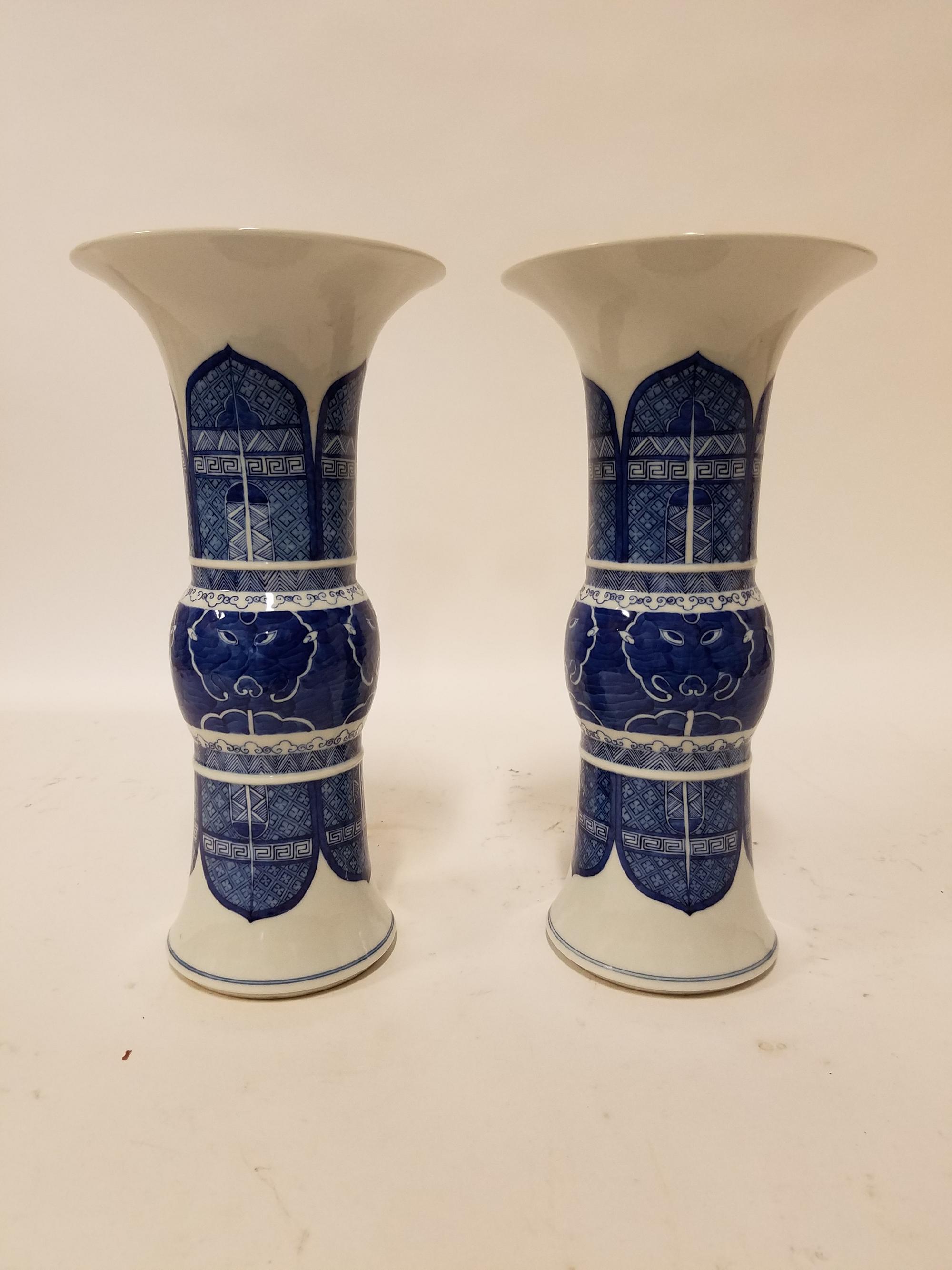 A Pair of Blue and White Gu Vases. Height of each 13 1/4 inches.