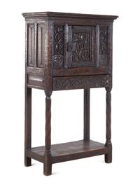 A Gothic Revival Carved Oak Cabinet on Stand