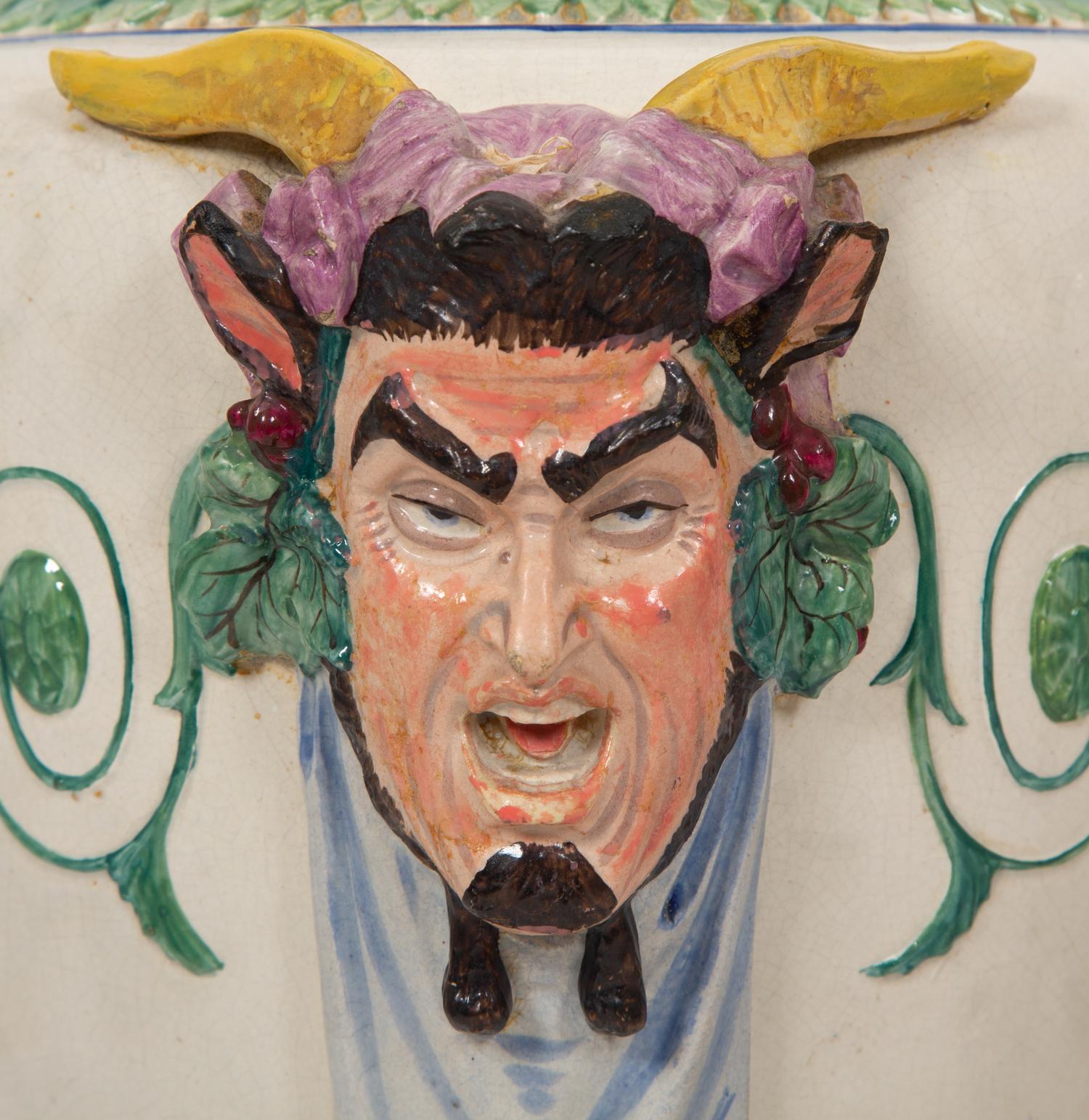 A Pair of Italian Glazed Ceramic Urns Decorated with Horned Masks and Paw Feet