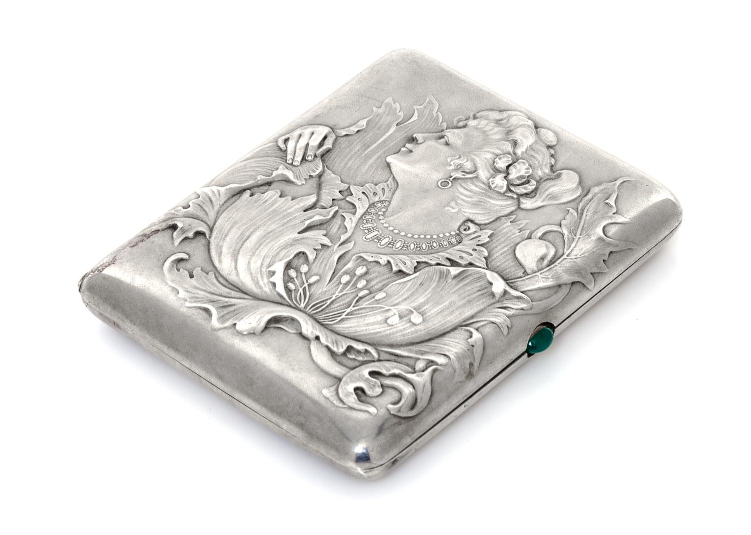 A Russian Silver Cigarette Case, Maker's mark obscured, assay mark of Ivan Lebedkin, Moscow, the lid with raised decoration showing a w