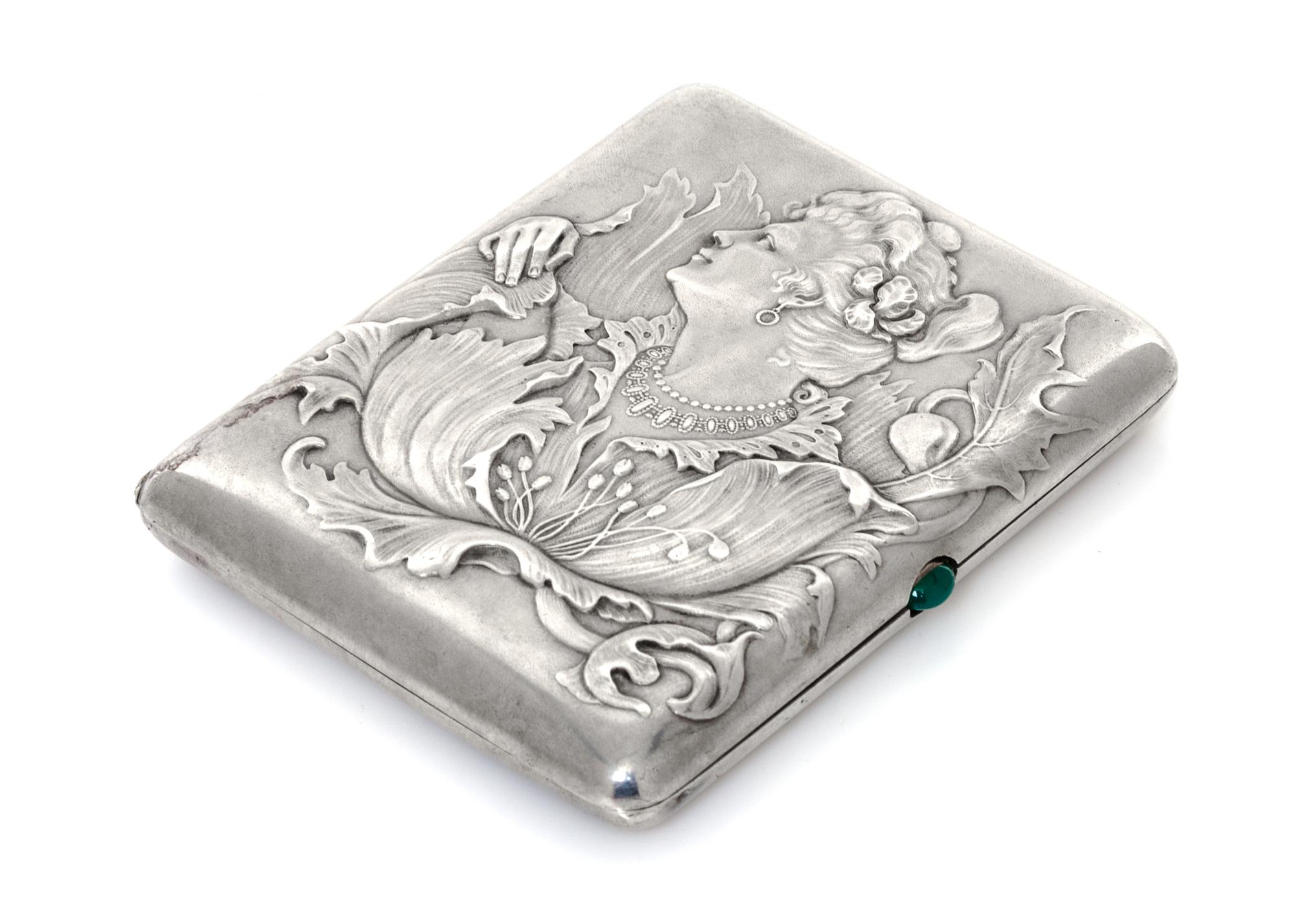 A Russian Silver Cigarette Case, Maker's mark obscured, assay mark of Ivan Lebedkin, Moscow, the lid with raised decoration showing a w
