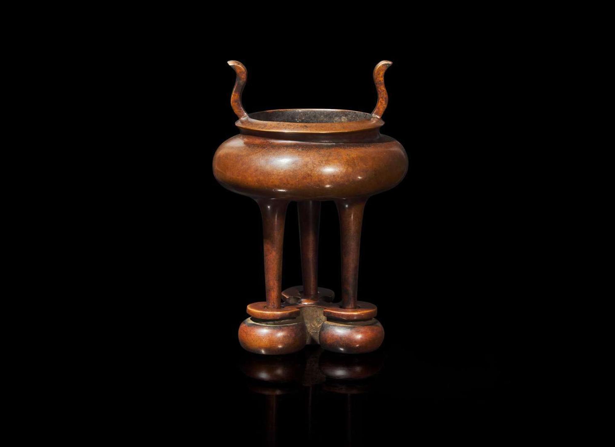 A Chinese patinated copper alloy tripod censer and stand, apocryphal "Xuan" mark 銅爐及底座 宣款