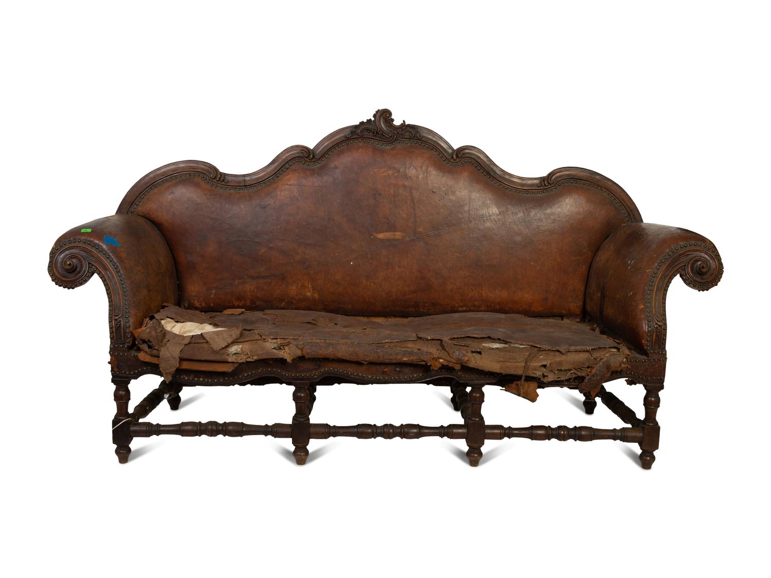 A Spanish Baroque Carved Walnut Leather-Upholstered Sofa — 17TH/18TH CENTURY