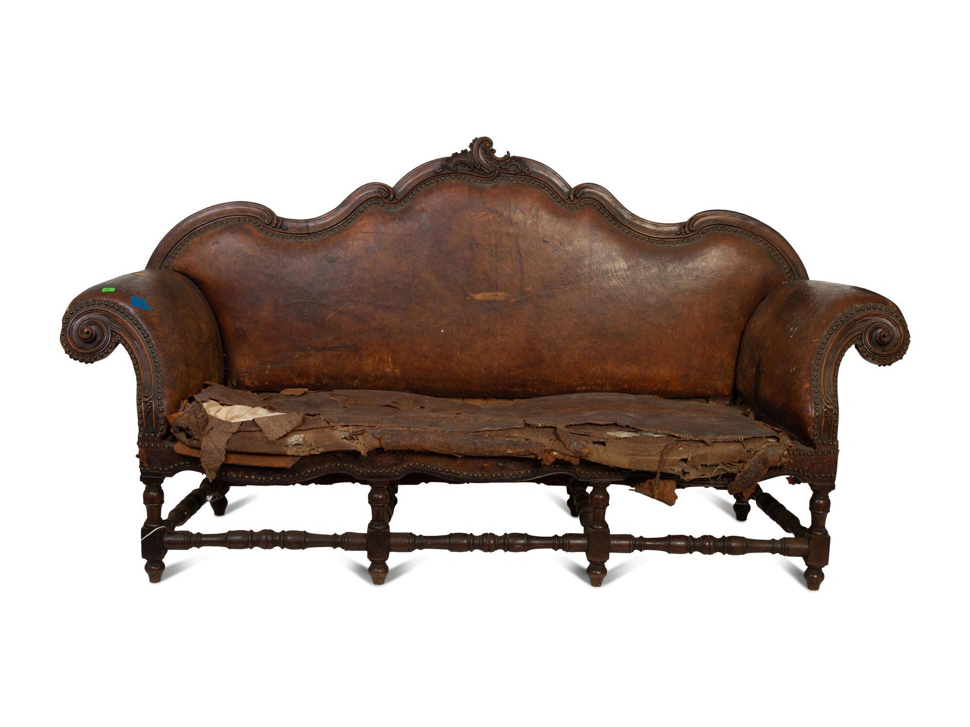 A Spanish Baroque Carved Walnut Leather-Upholstered Sofa — 17TH/18TH CENTURY