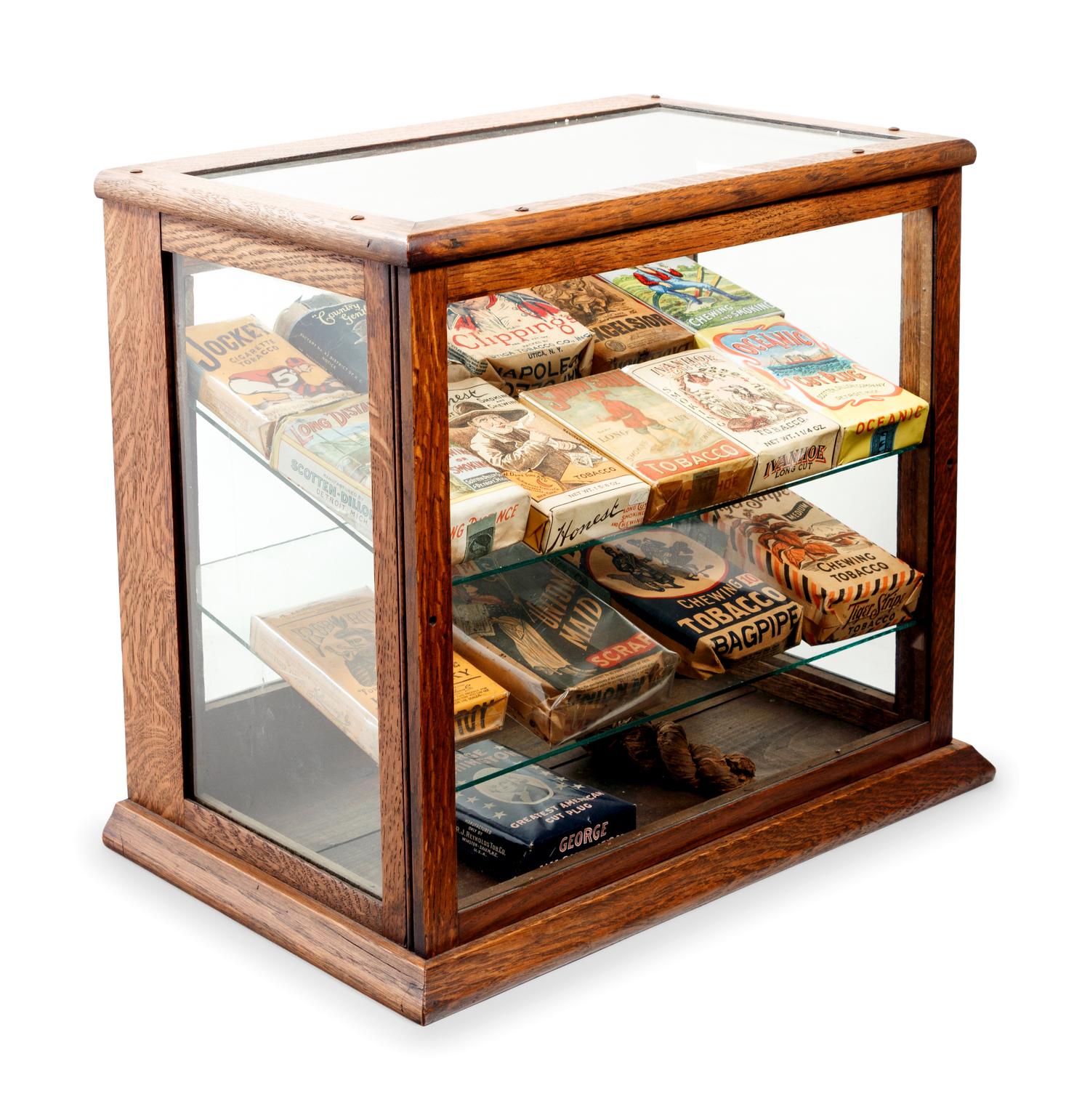 A Collection of Fifteen Tobacco Cartons and a Tobacco Rope in Display Case