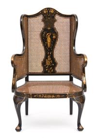 A Regency Style Black and Gilt Chinoiserie Decorated Caned Wing Chair Height 50 inches. — 20TH CENTURY