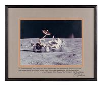 YOUNG, John Watts (1930-2018). Photograph of Young driving a moon buggy, signed (“John Young”) to Ambassador Edward Joseph Perkins.