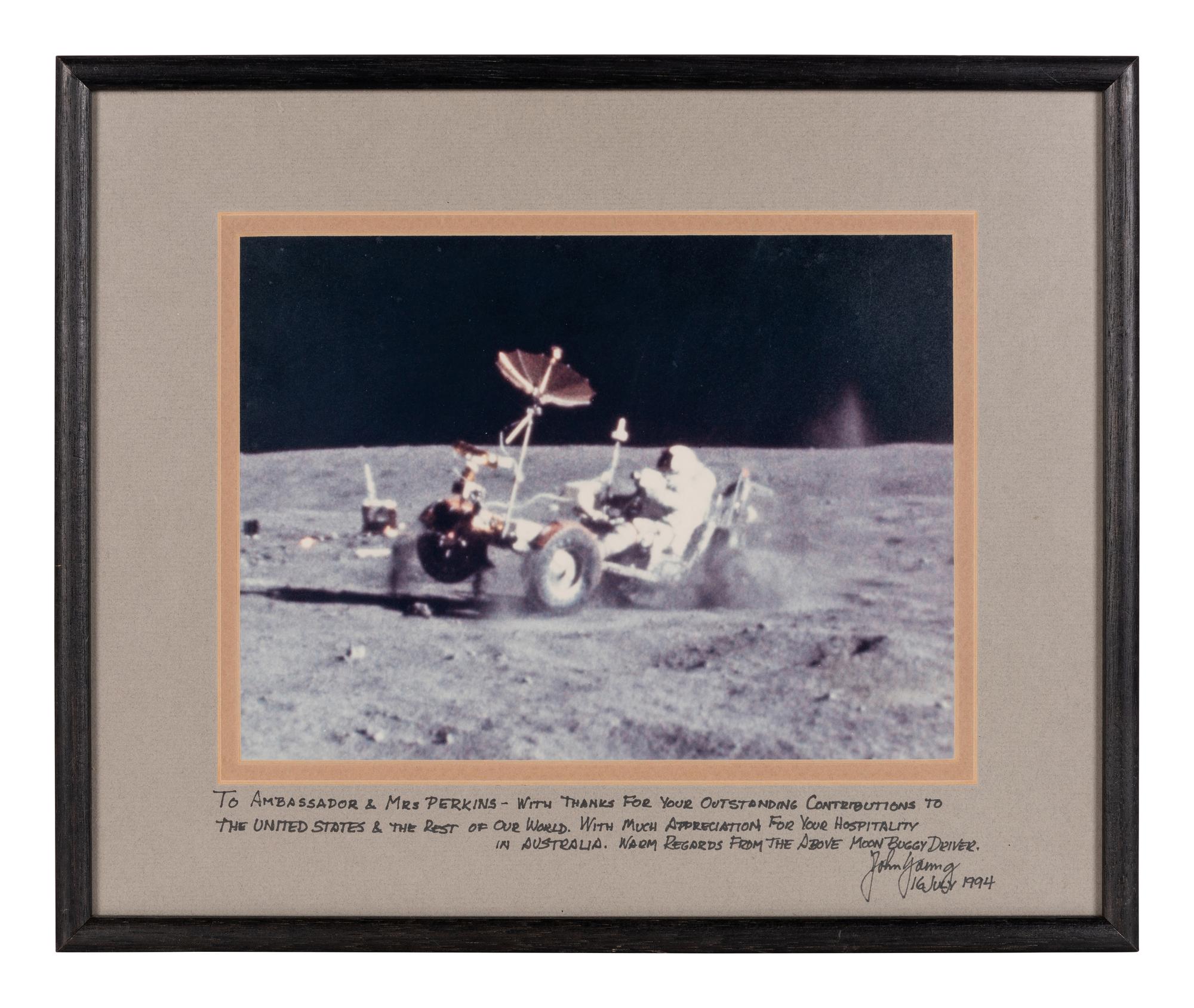 YOUNG, John Watts (1930-2018). Photograph of Young driving a moon buggy, signed (“John Young”) to Ambassador Edward Joseph Perkins.