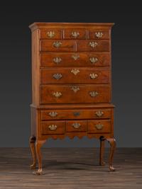 A Queen Anne Figured Walnut Flat-Top Trifid-Foot High Chest