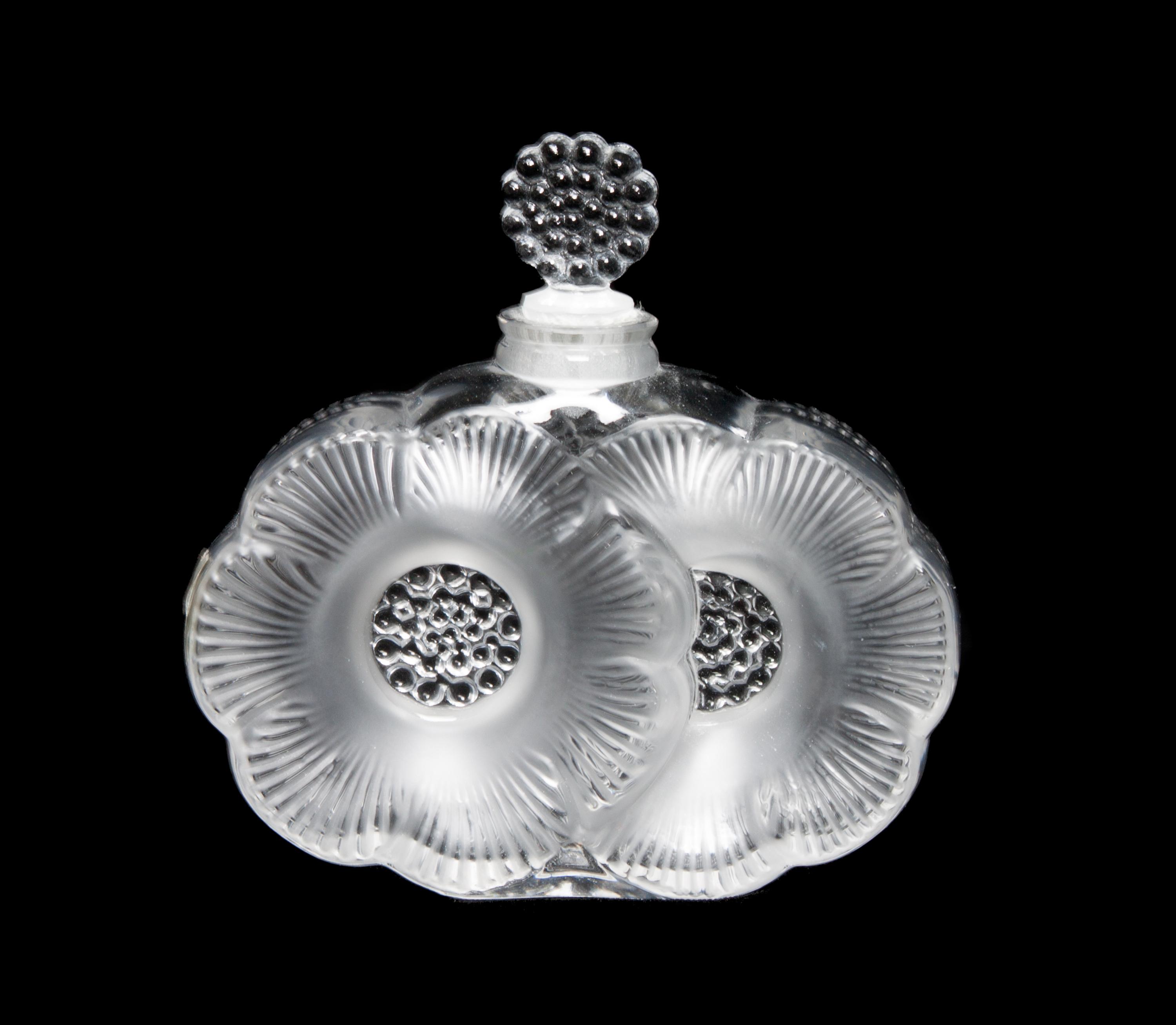 A Lalique Molded and Frosted Glass Perfume Bottle Height 3 3/4 inches.