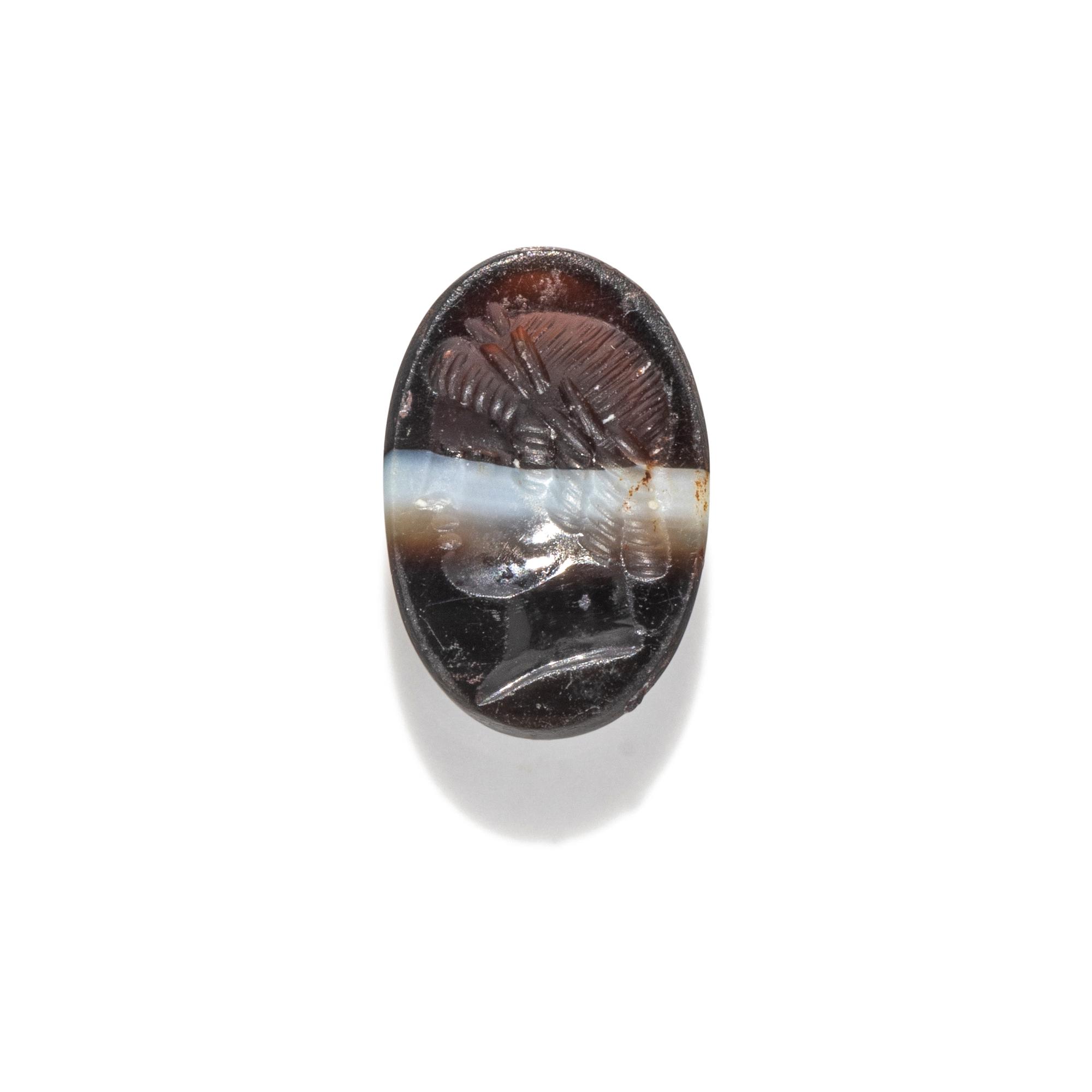 A Roman Banded Agate Ring Stone with a Portrait Head of the God Apollo