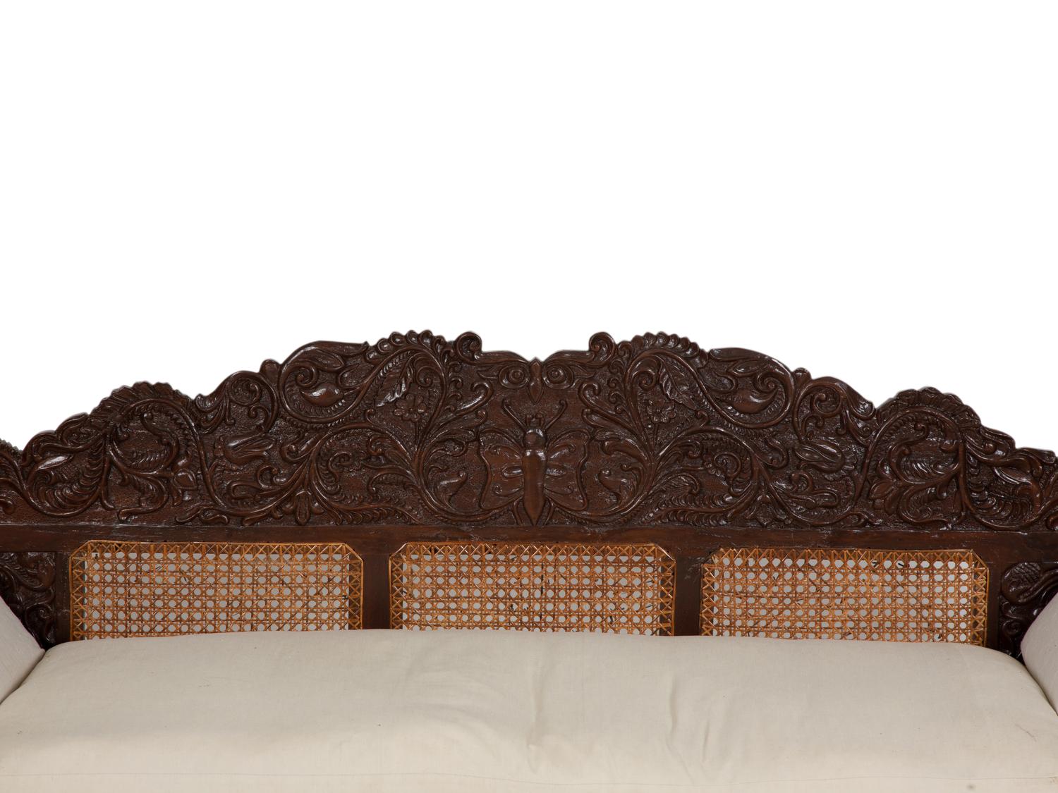 A British Colonial Carved Mahogany and Cane Work Settee