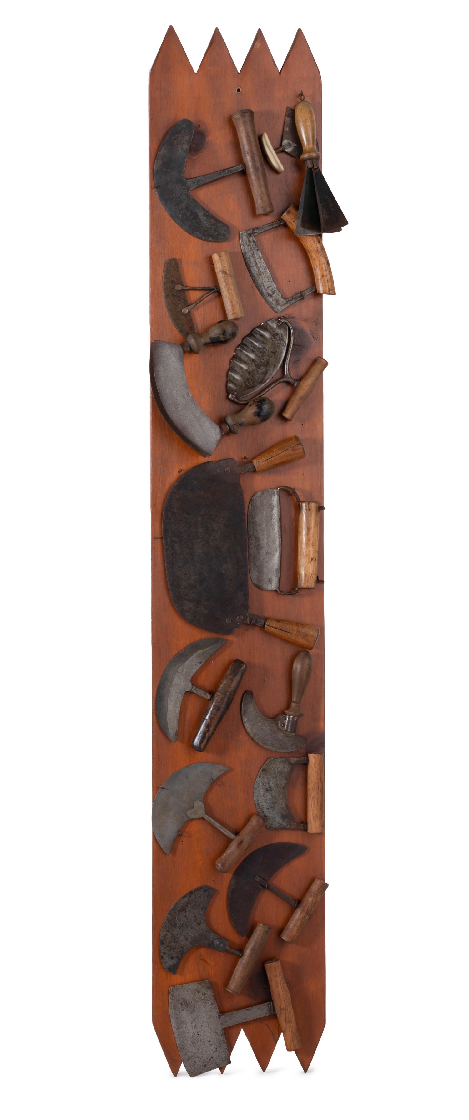 A Collection of Wrought Iron Kitchen Tools Mounted to Panel