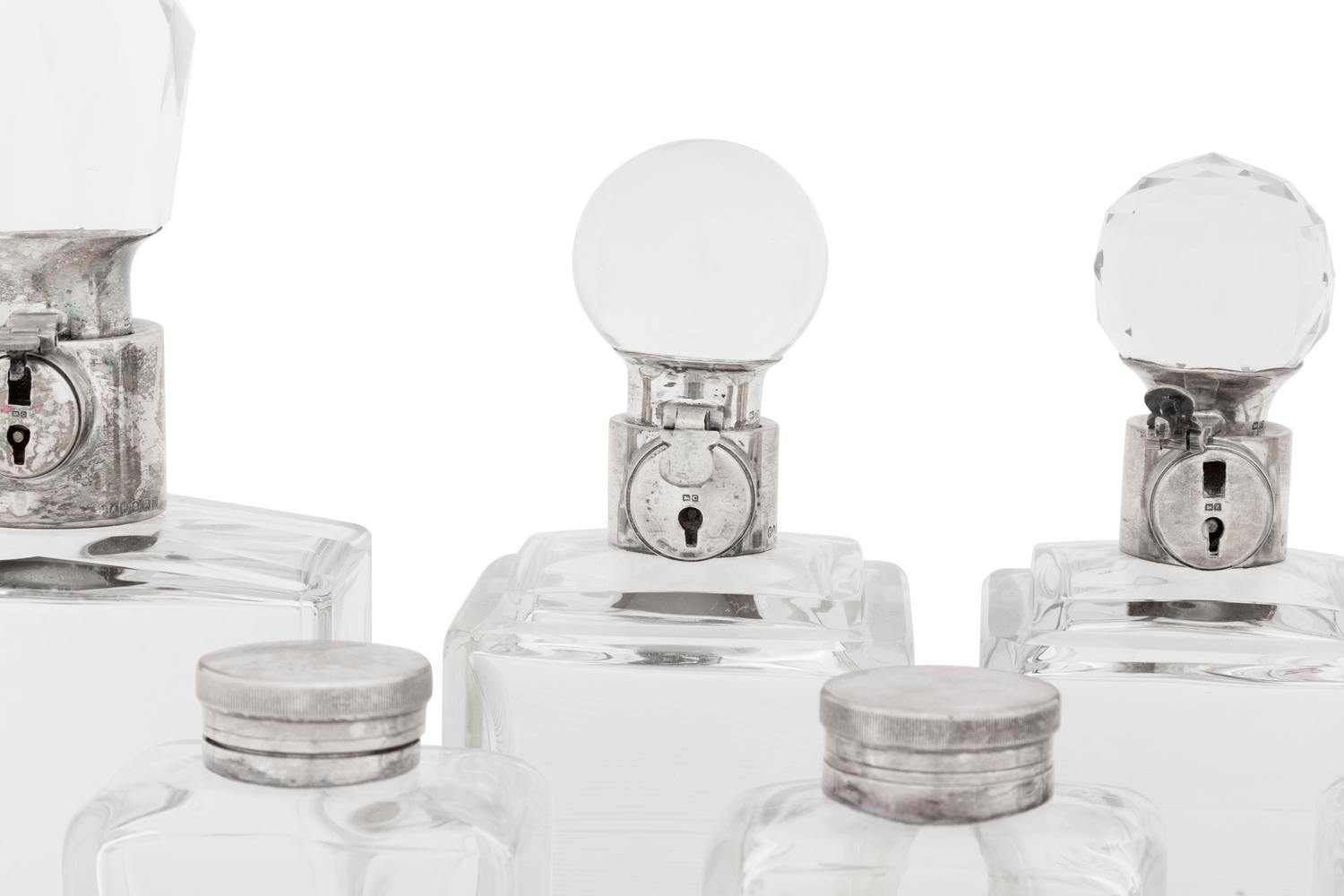 Seven Silver and Silver-Plate Mounted Glass Decanters