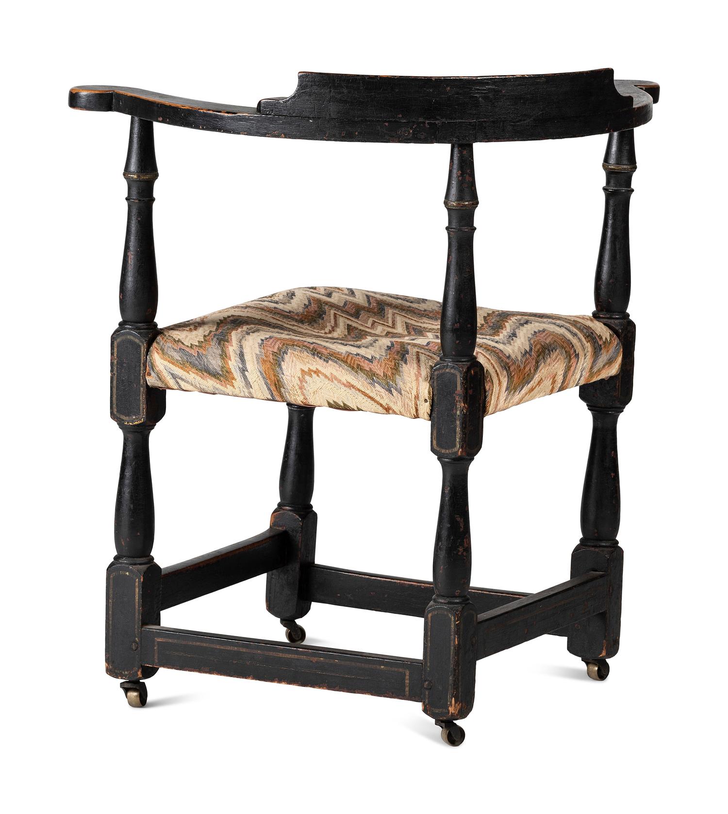 A William and Mary Black Painted and Parcel Gilt Roundabout Corner Chair