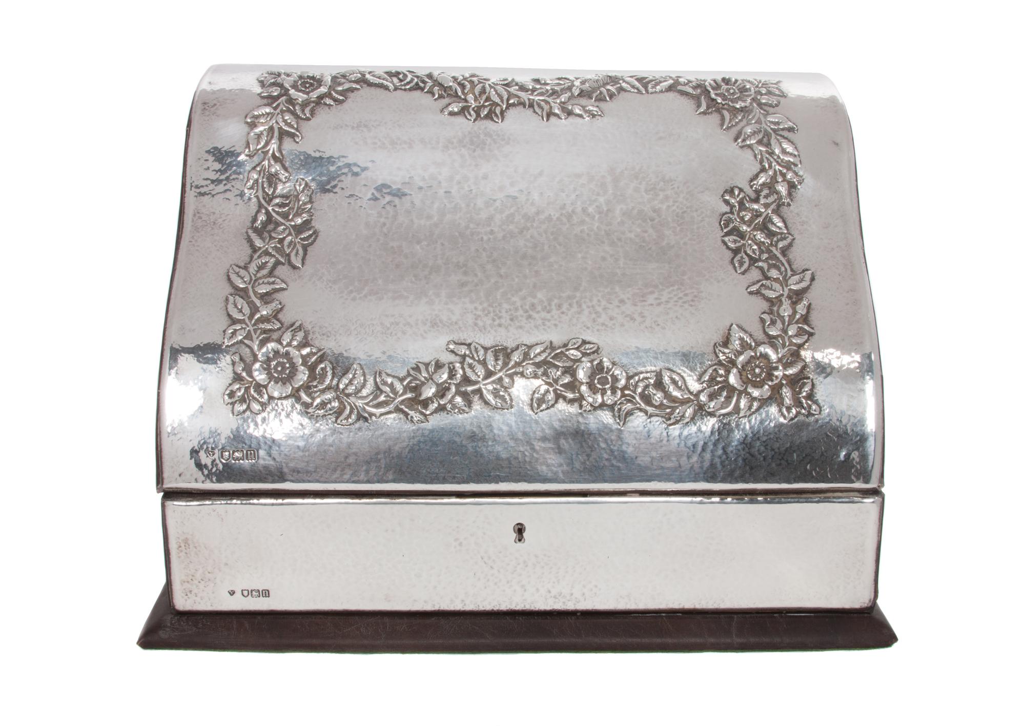 An Edwardian Silver Stationery Box, Holland, Aldwinckle & Slater, London, 1908-09, with spot hammered surfaces, the hinged lid decorate