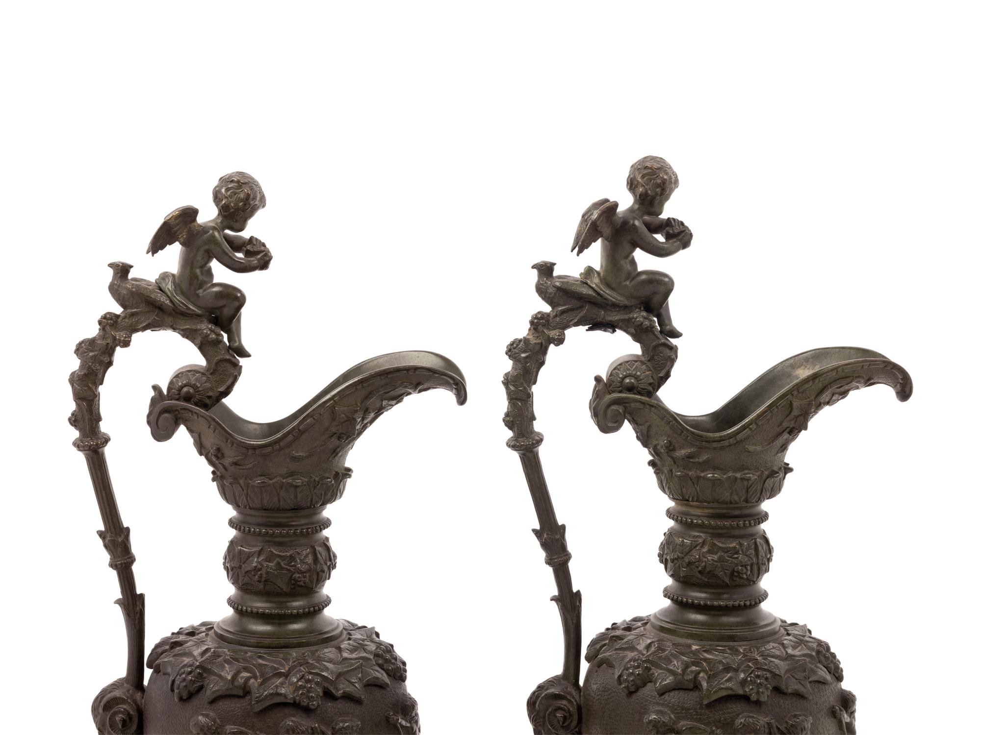 A Pair of Neoclassical Patinated Bronze Ewers with Bacchic Putti