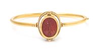 An Egyptian Revival Yellow Gold, Carved Carnelian Scarab and Enamel Bangle Bracelet, Carlo Giuliano, 8.50 dwts.