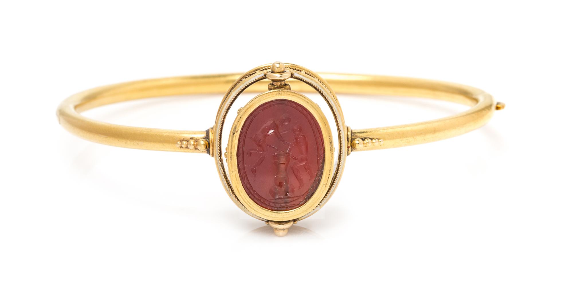 An Egyptian Revival Yellow Gold, Carved Carnelian Scarab and Enamel Bangle Bracelet, Carlo Giuliano, 8.50 dwts.