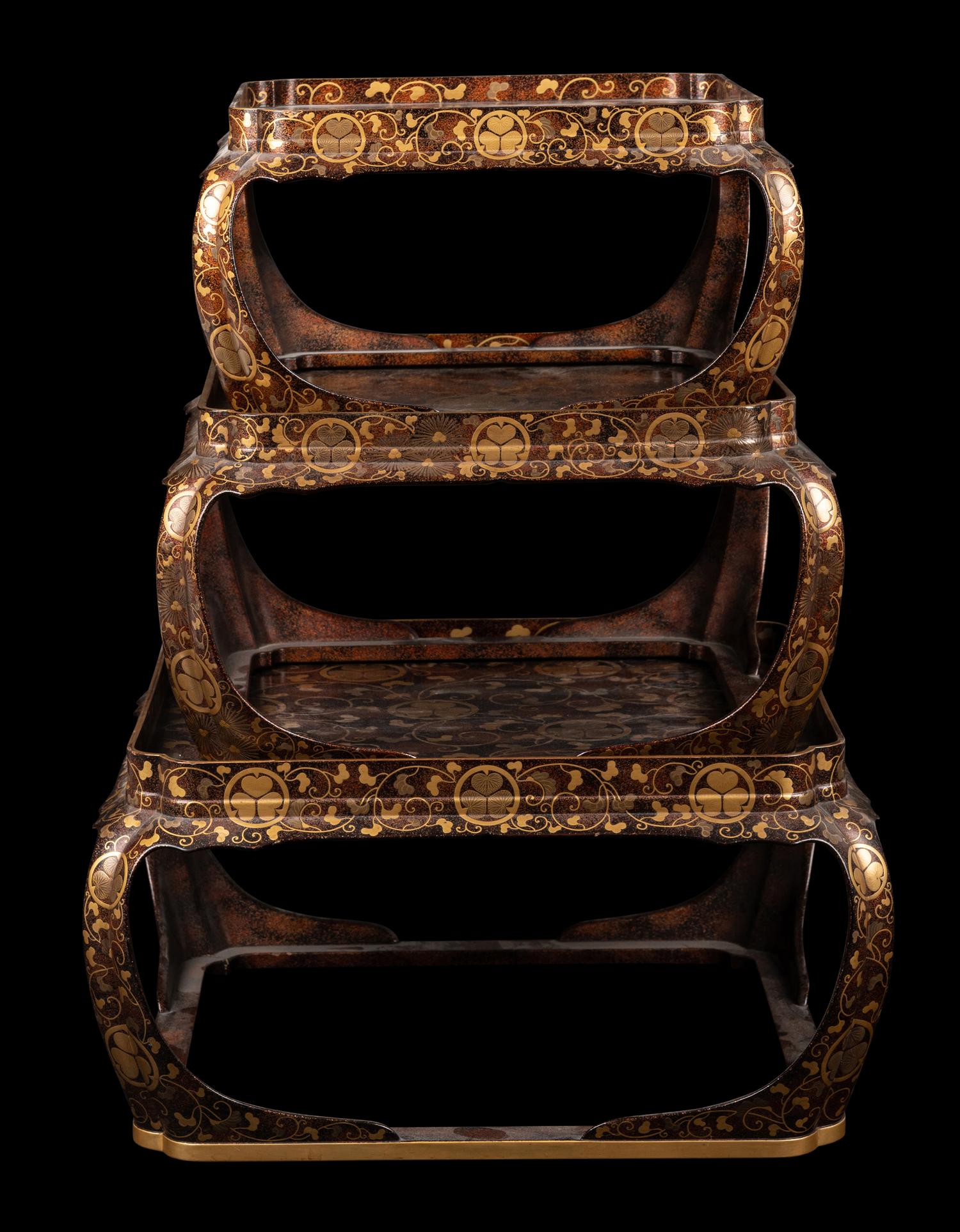 A Set of Three Japanese Gilt Decorated Lacquer Nesting Tables