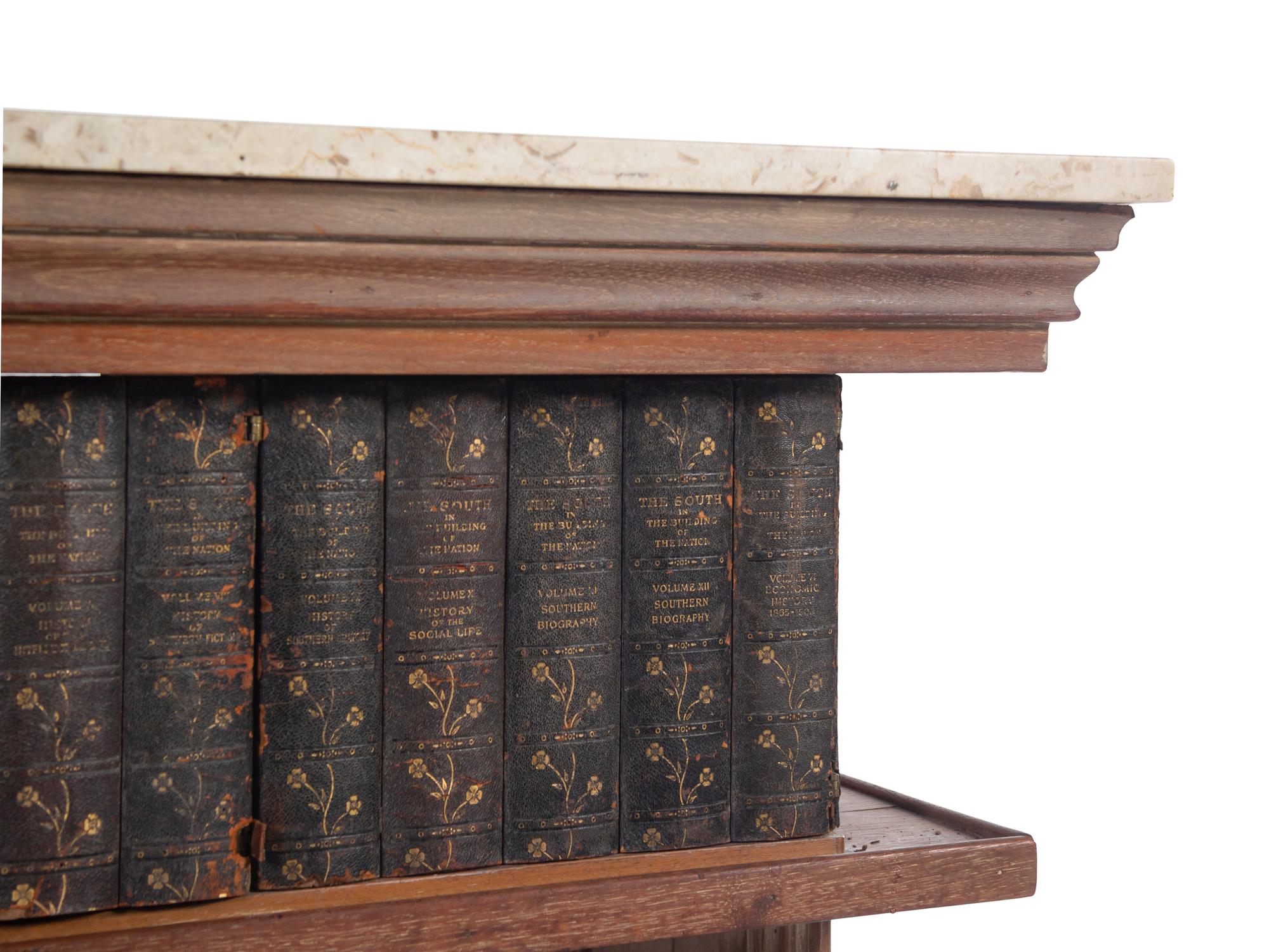 A Carved Marble-Top Console Table with Faux Books