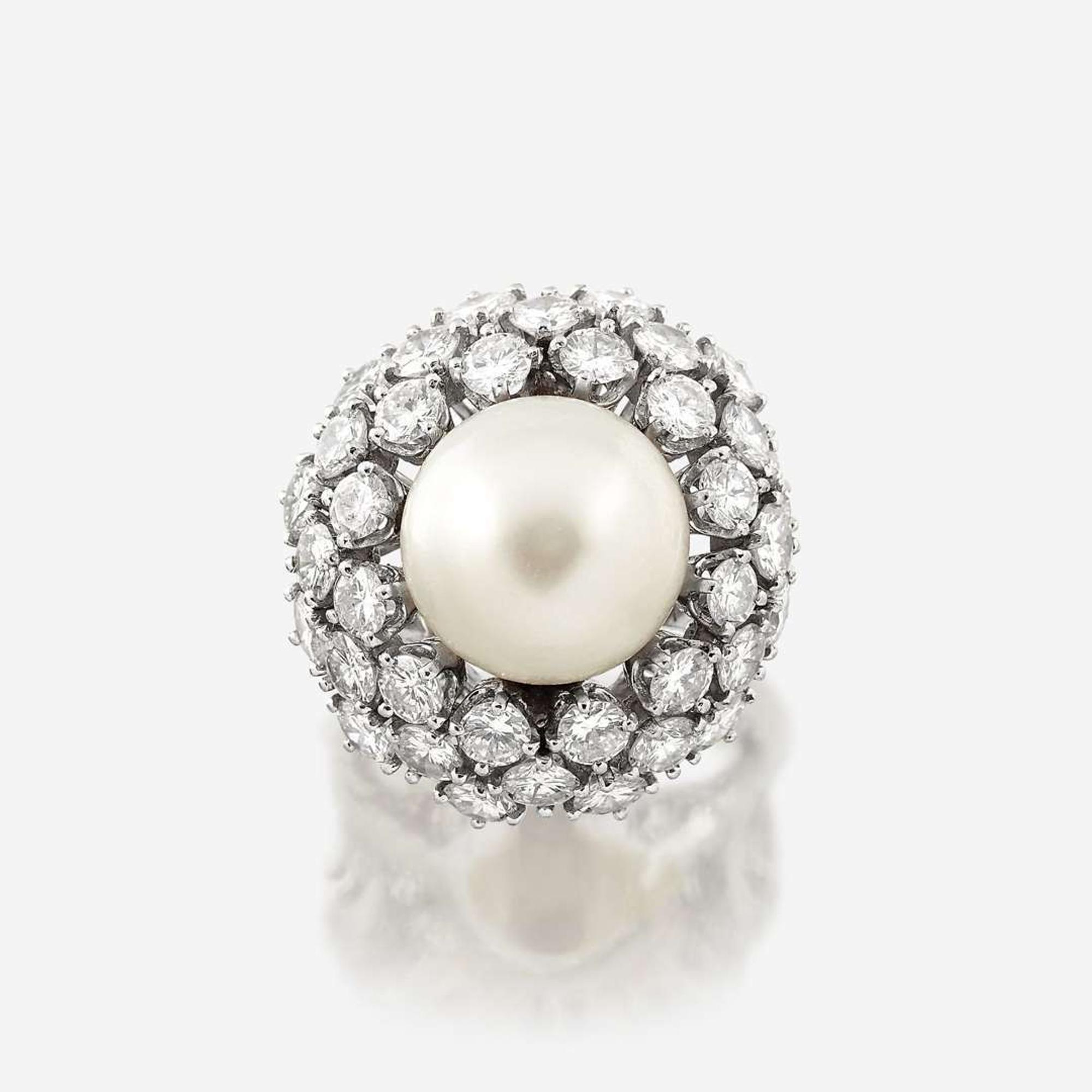 A cultured pearl, diamond, and eighteen karat white gold ring