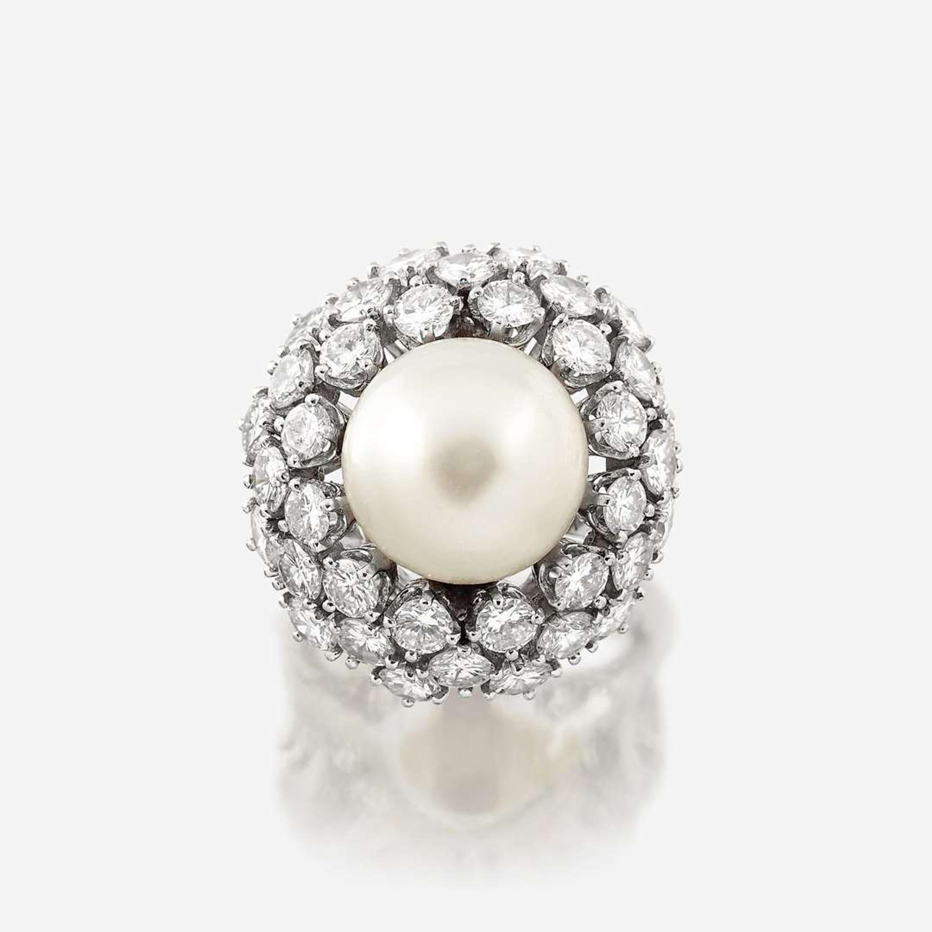 A cultured pearl, diamond, and eighteen karat white gold ring