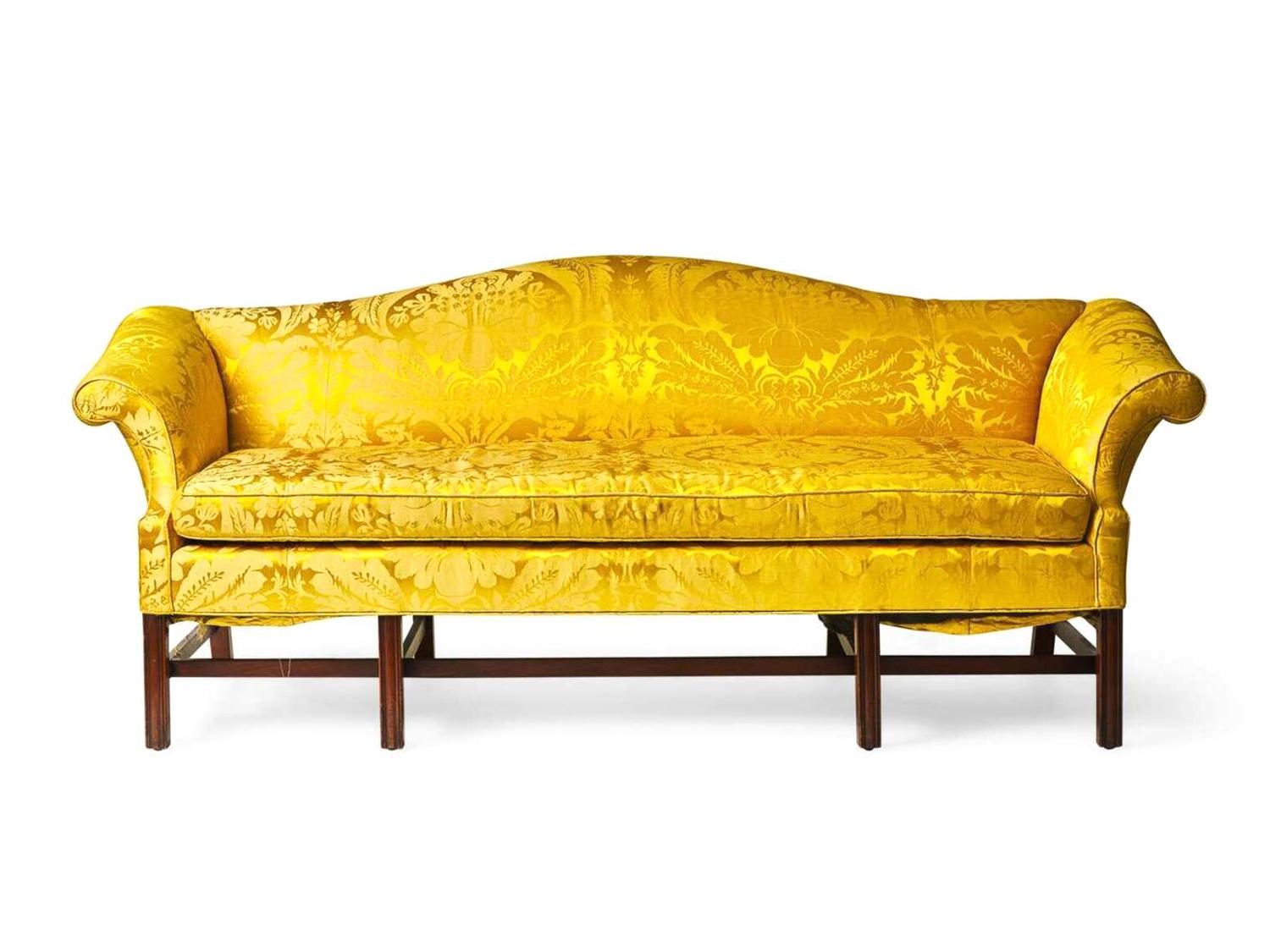 A Chippendale style mahogany camelback sofa with yellow silk damask upholstery, late 19th or 20th century