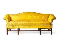 A Chippendale style mahogany camelback sofa with yellow silk damask upholstery, late 19th or 20th century