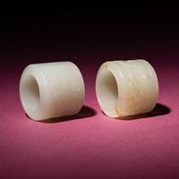 Two Chinese White Jade 'Animal' Archer's Rings, 18th Century — 清中期 白玉刻動物紋扳指兩枚