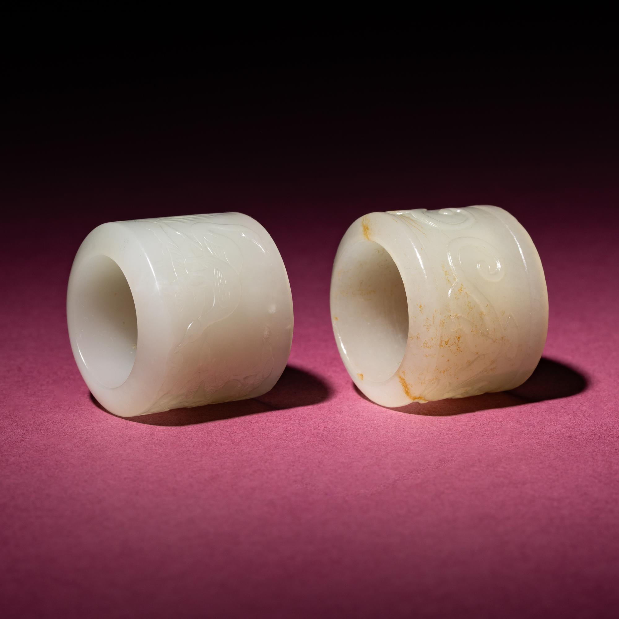 Two Chinese White Jade 'Animal' Archer's Rings, 18th Century — 清中期 白玉刻動物紋扳指兩枚